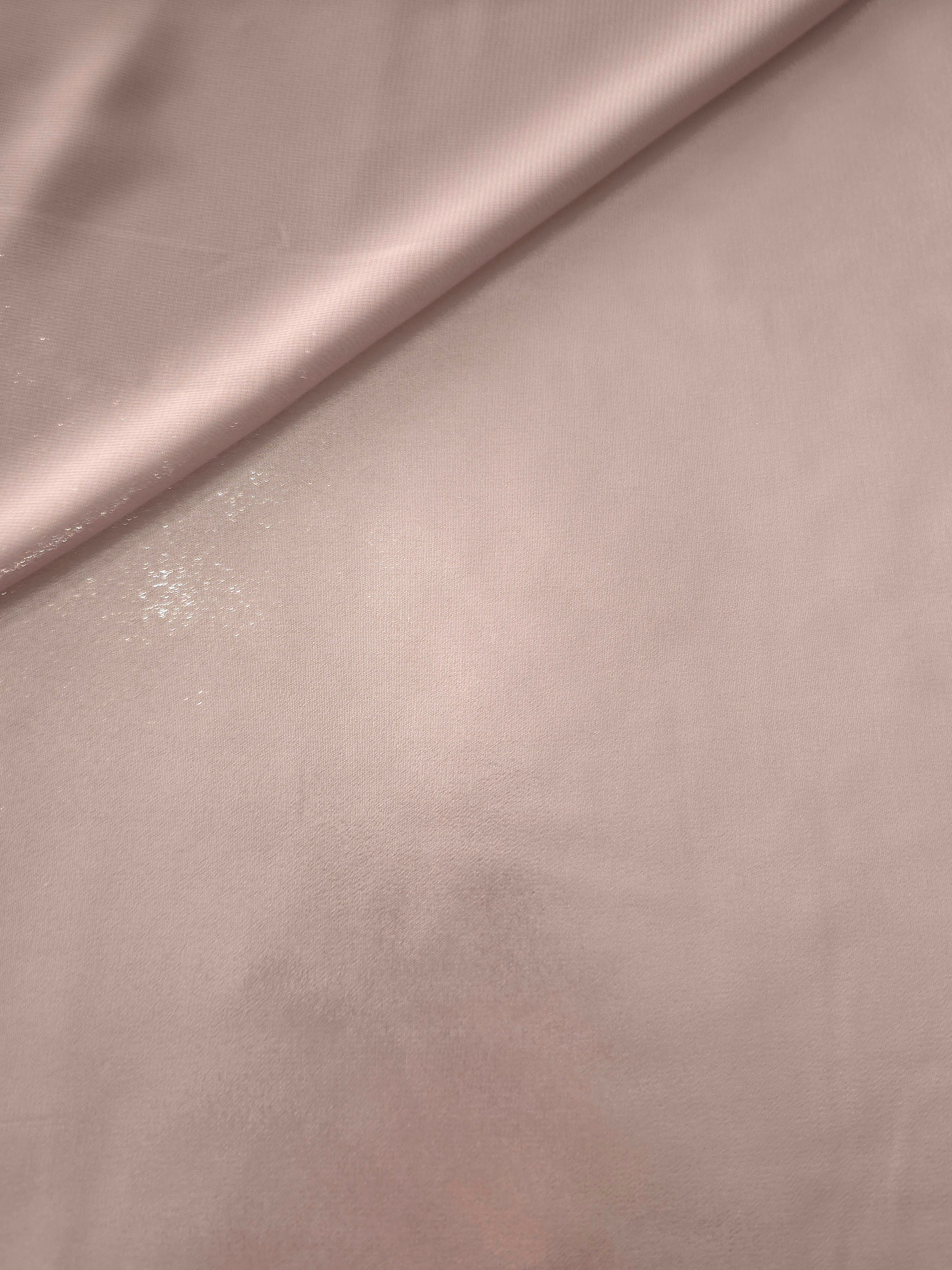 Rose blush folded view of liquid metallic shimmer chiffon fabric, showing lightweight reflective fabric texture and drape
