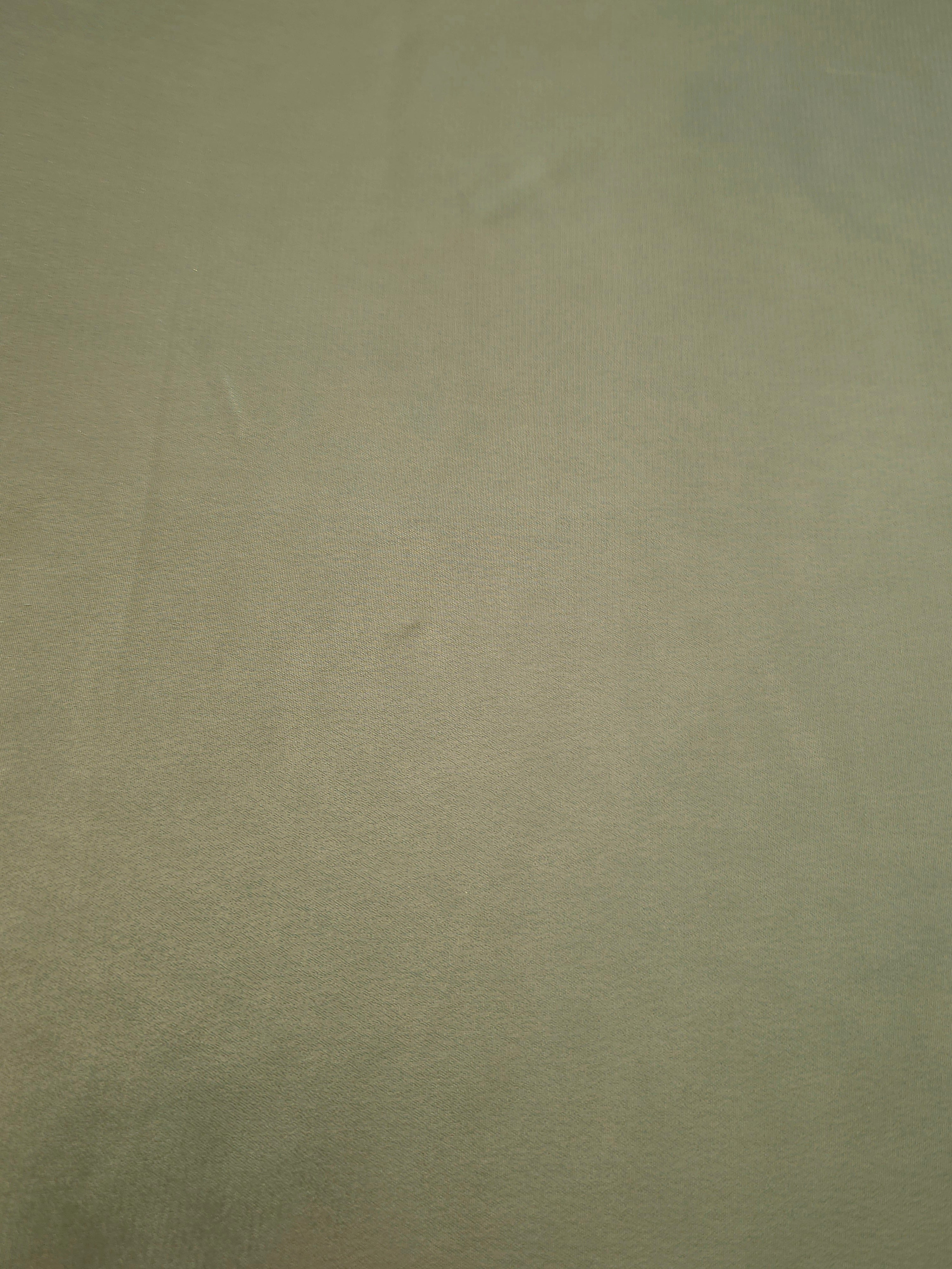 Sage green fabric overview view of liquid metallic shimmer chiffon fabric, highlighting fluid folds and reflective surface