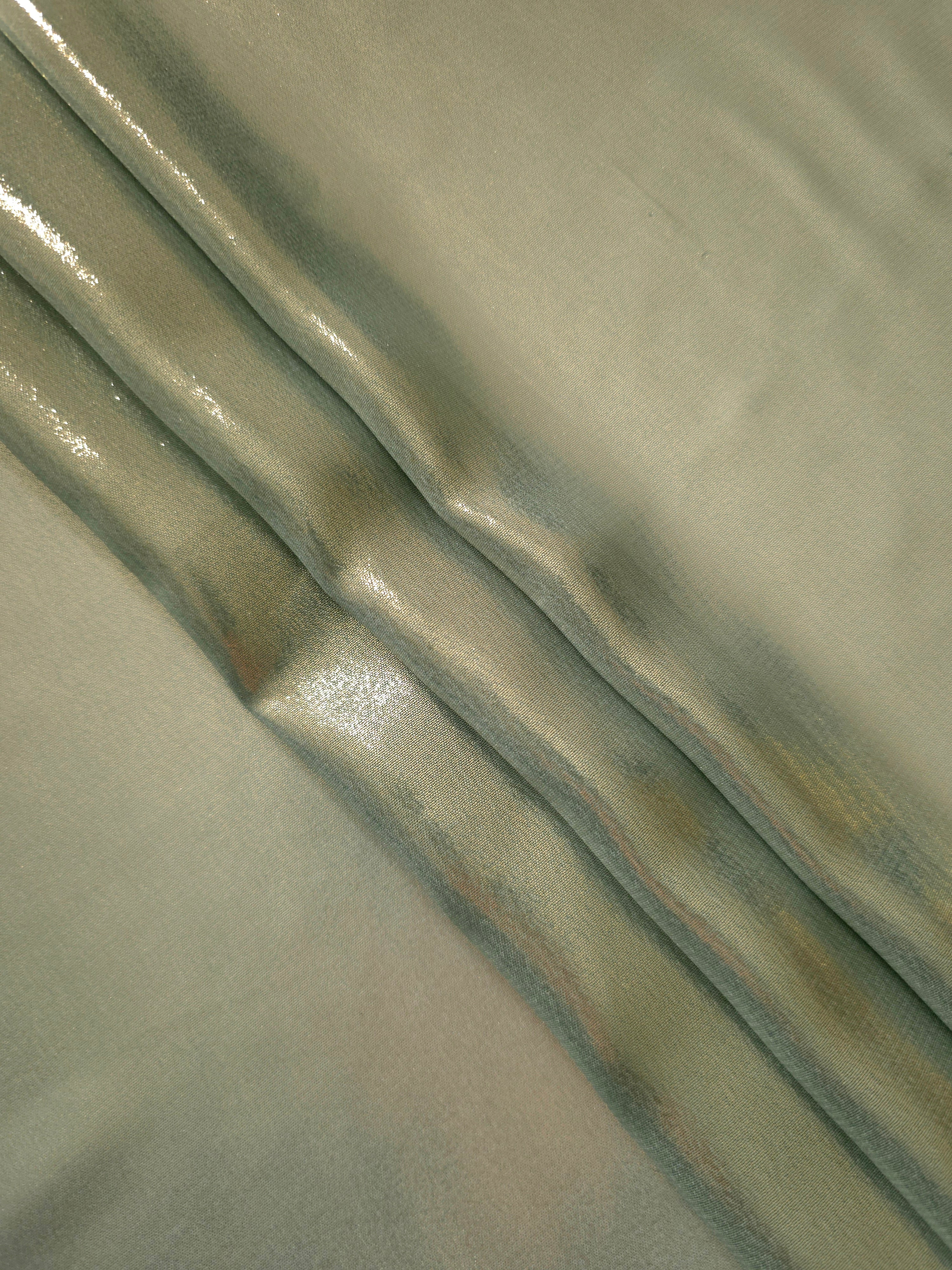 Sage green flowing folds view of liquid metallic shimmer chiffon fabric, highlighting fluid folds and reflective surface