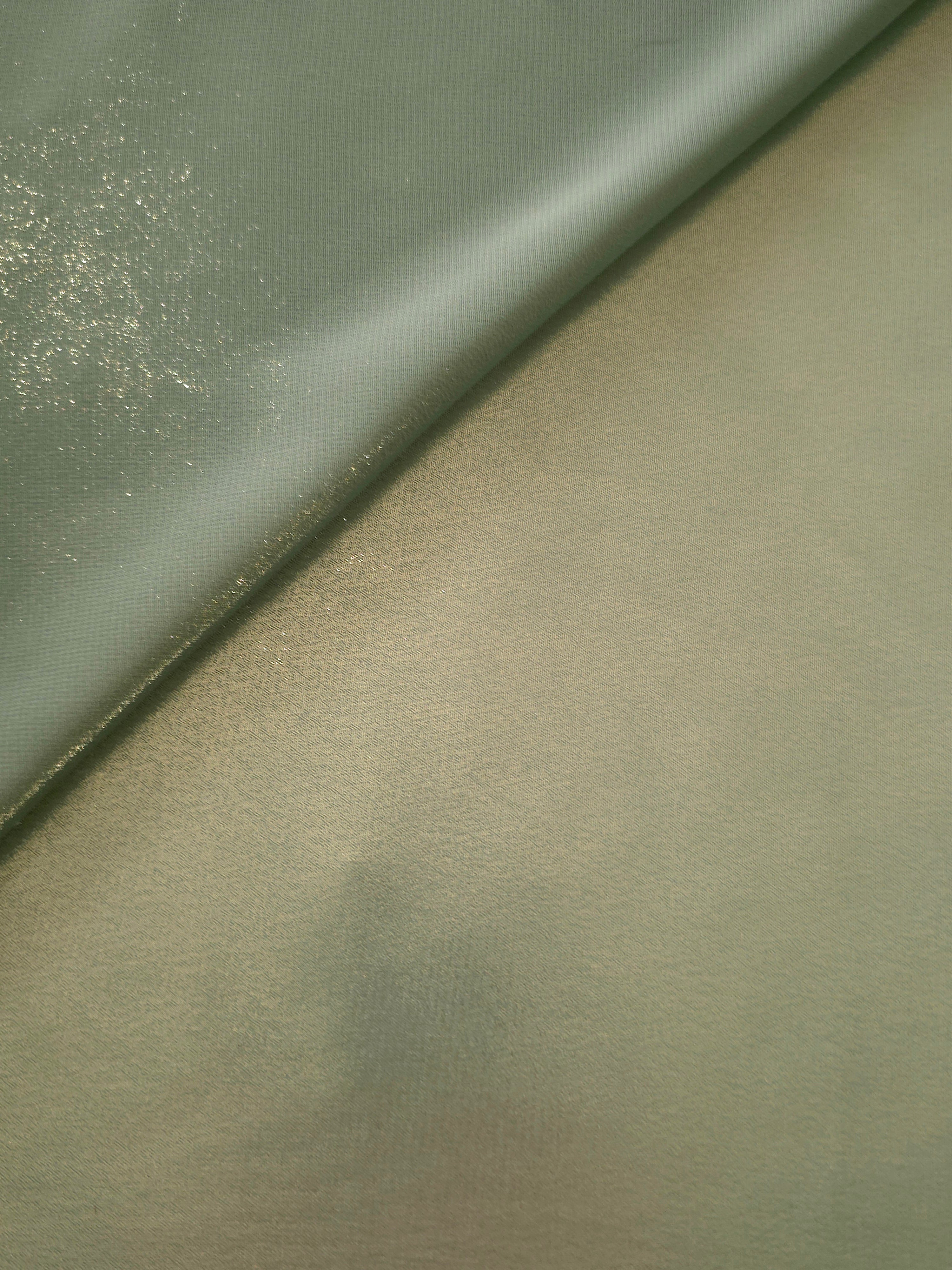 Sage green soft draping view of liquid metallic shimmer chiffon fabric, highlighting fluid folds and reflective surface