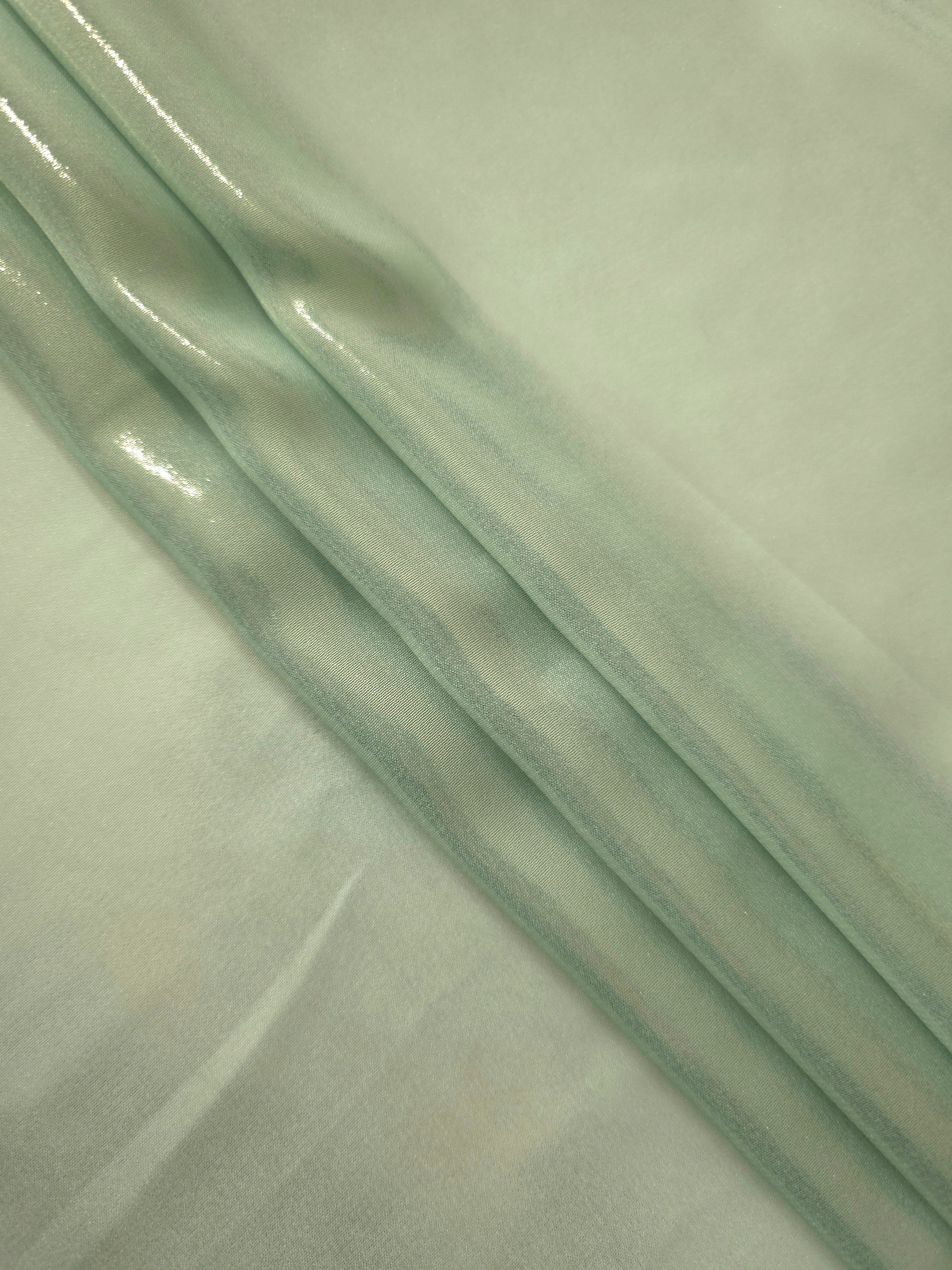 Sage silver flowing folds of liquid metallic shimmer chiffon fabric, showing lightweight reflective fabric texture and drape