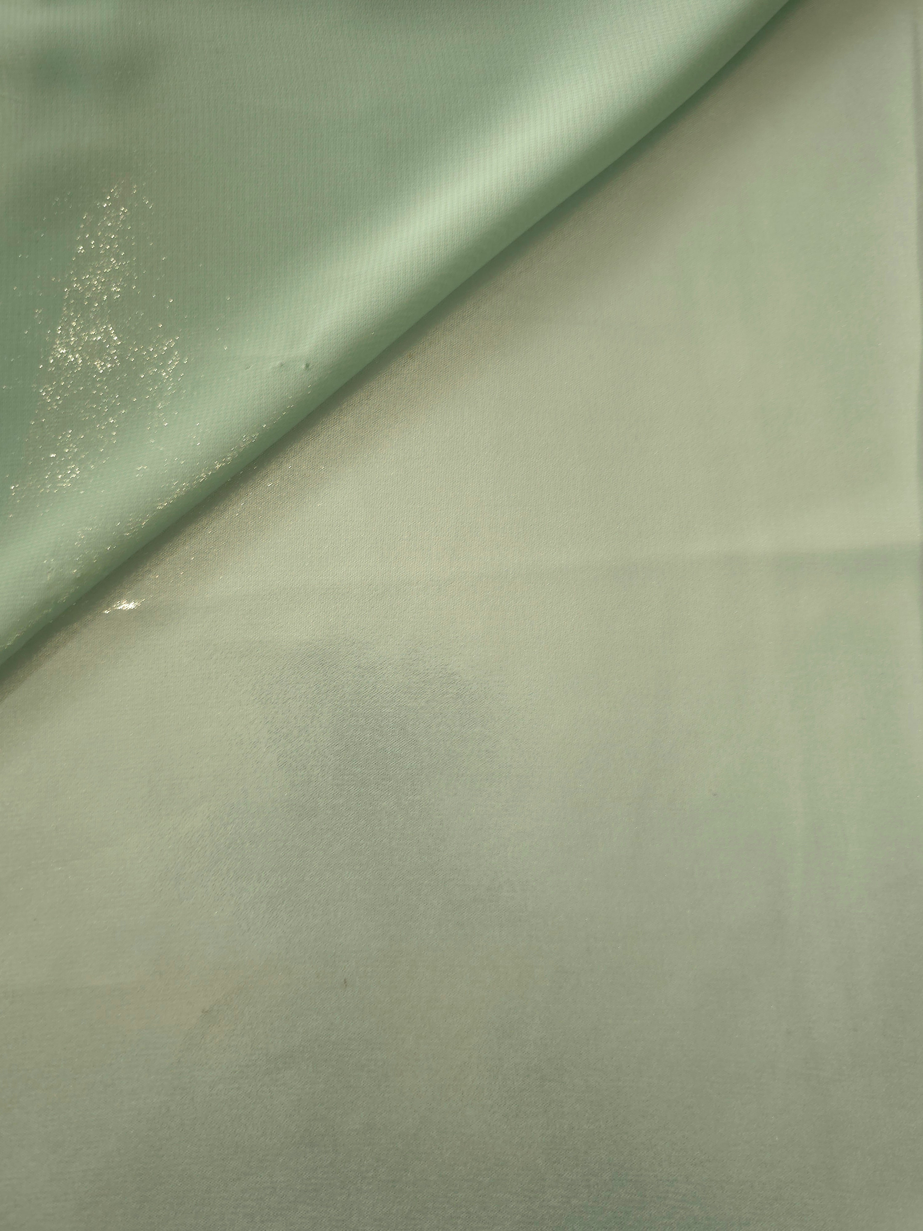 Sage silver soft draping of liquid metallic shimmer chiffon fabric, showing lightweight reflective fabric texture and drape