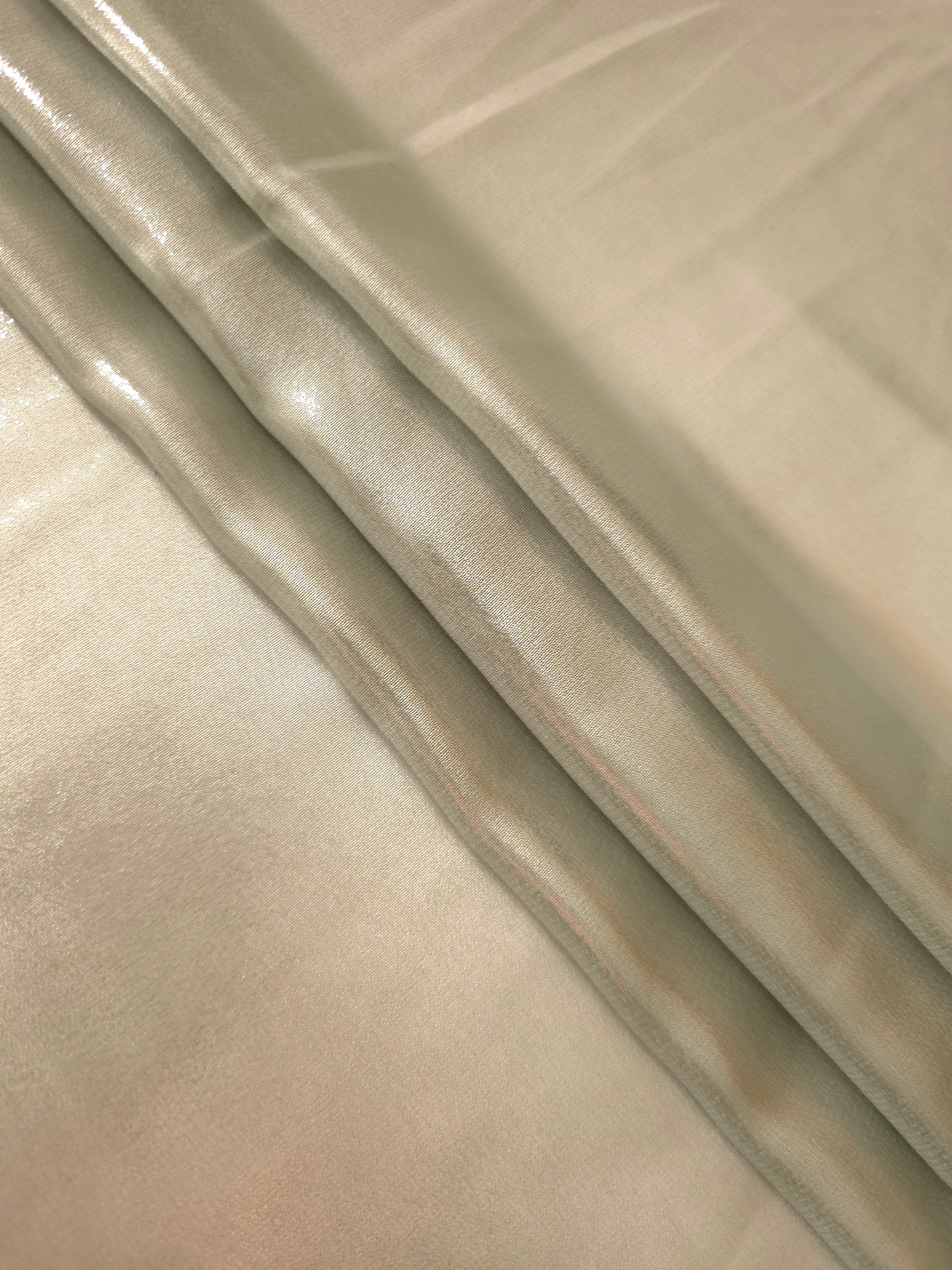 Silver sage flowing folds of liquid metallic shimmer chiffon fabric, showing lightweight reflective fabric texture and drape