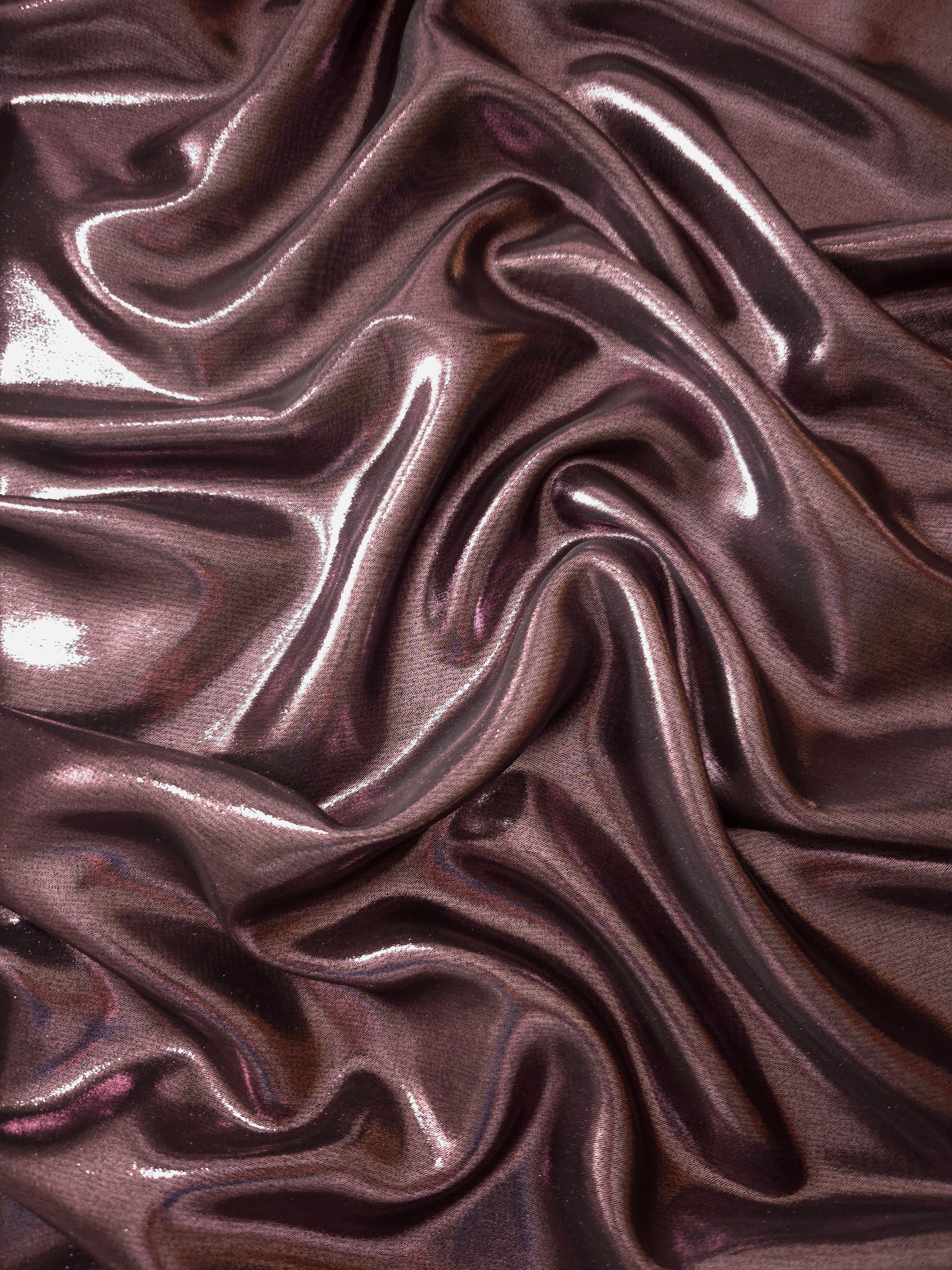 Smoky mauve surface detail view of liquid metallic shimmer chiffon fabric, highlighting fluid folds and reflective surface