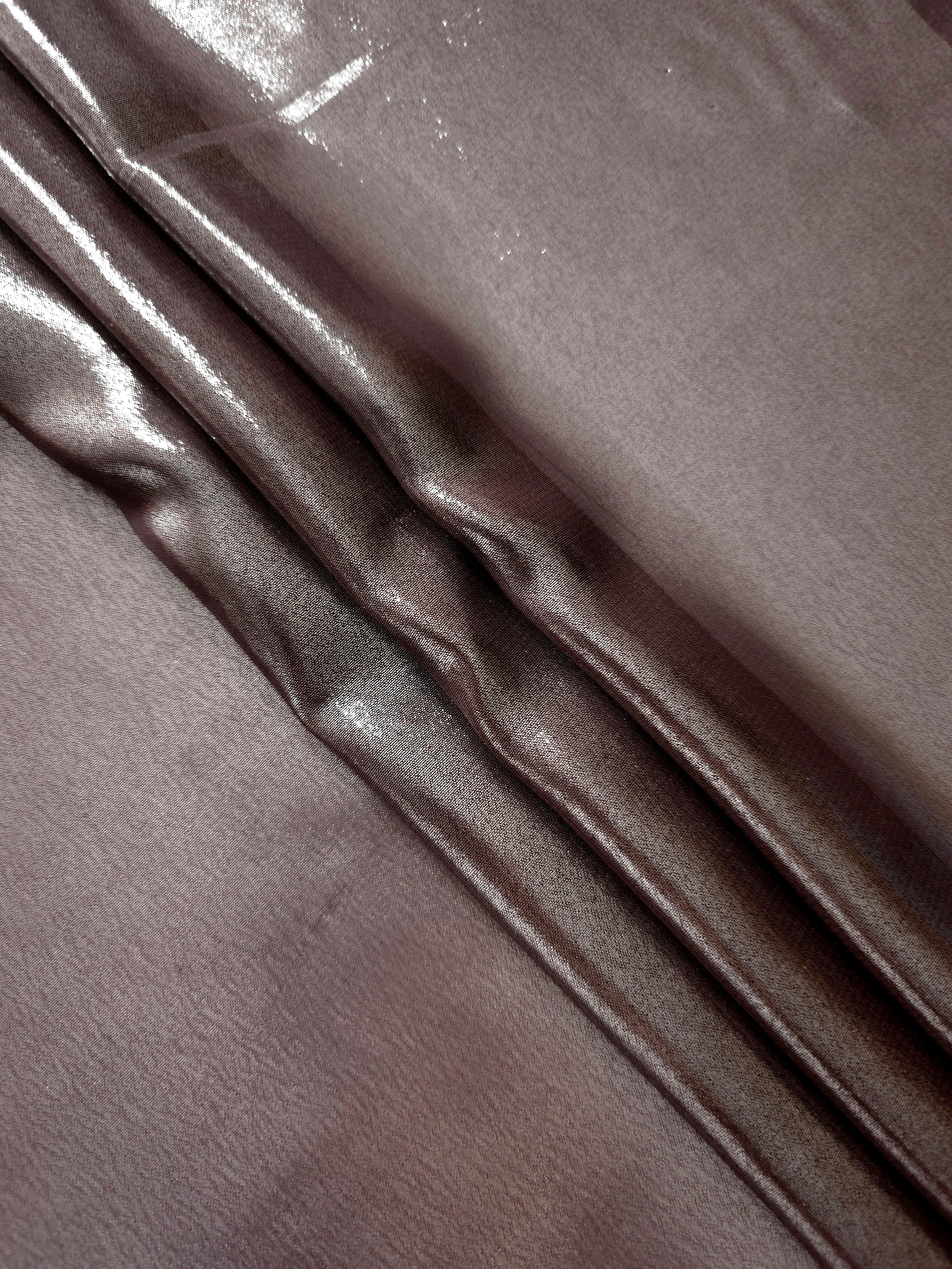 Smoky pewter flowing folds view of liquid metallic shimmer chiffon fabric, highlighting fluid folds and reflective surface