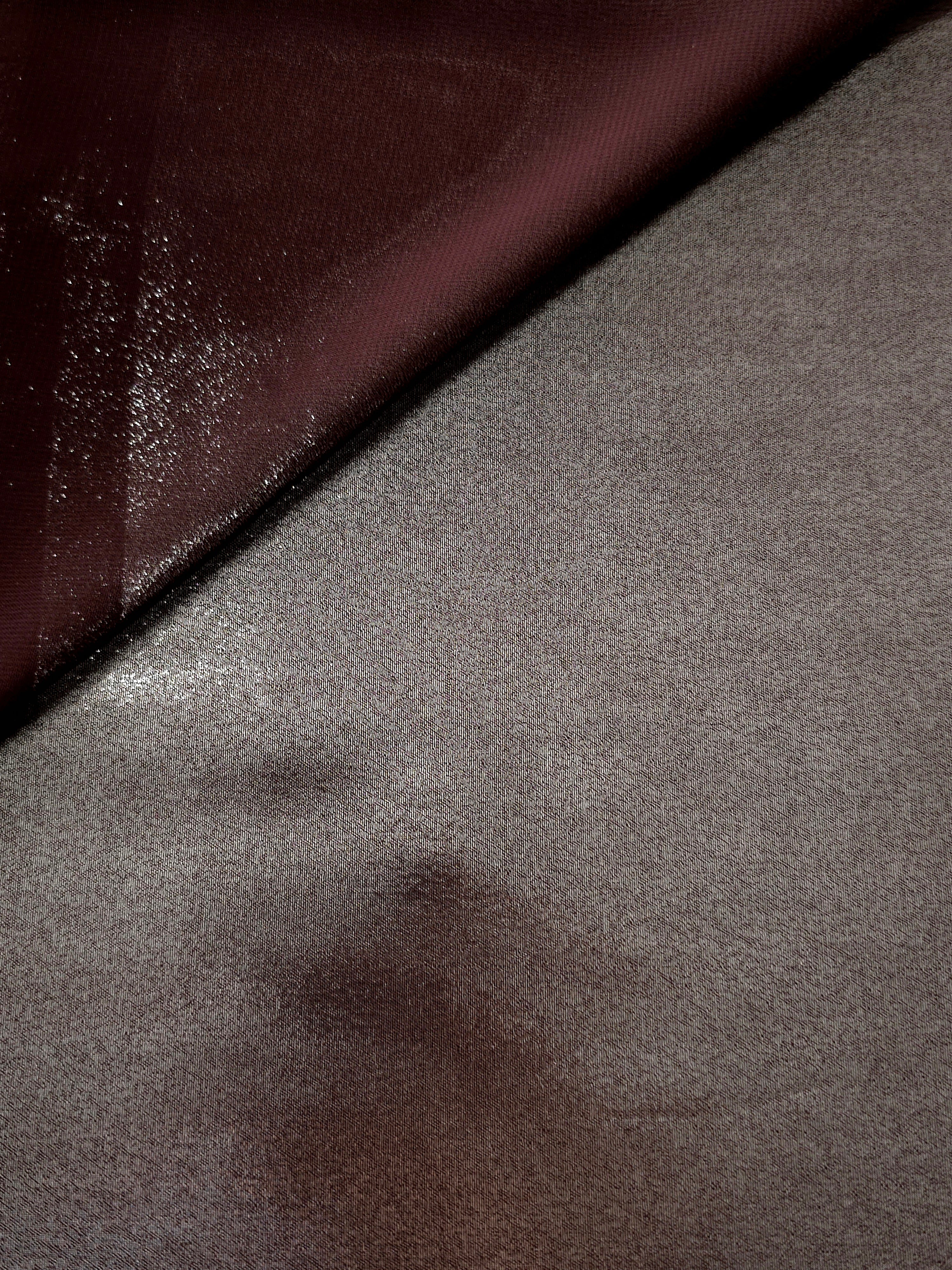 Smoky pewter soft draping view of liquid metallic shimmer chiffon fabric, highlighting fluid folds and reflective surface