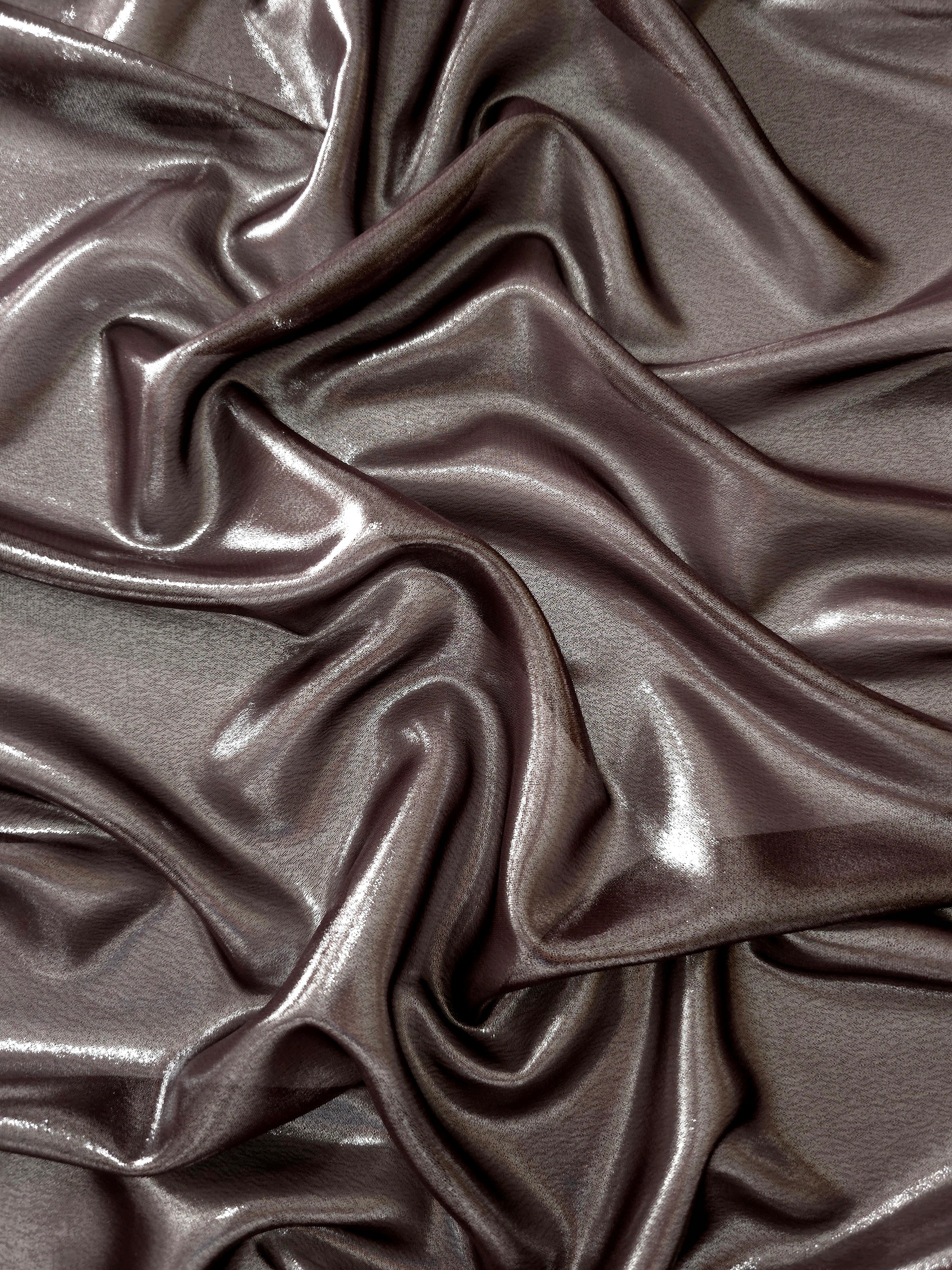 Smoky pewter surface detail view of liquid metallic shimmer chiffon fabric, highlighting fluid folds and reflective surface