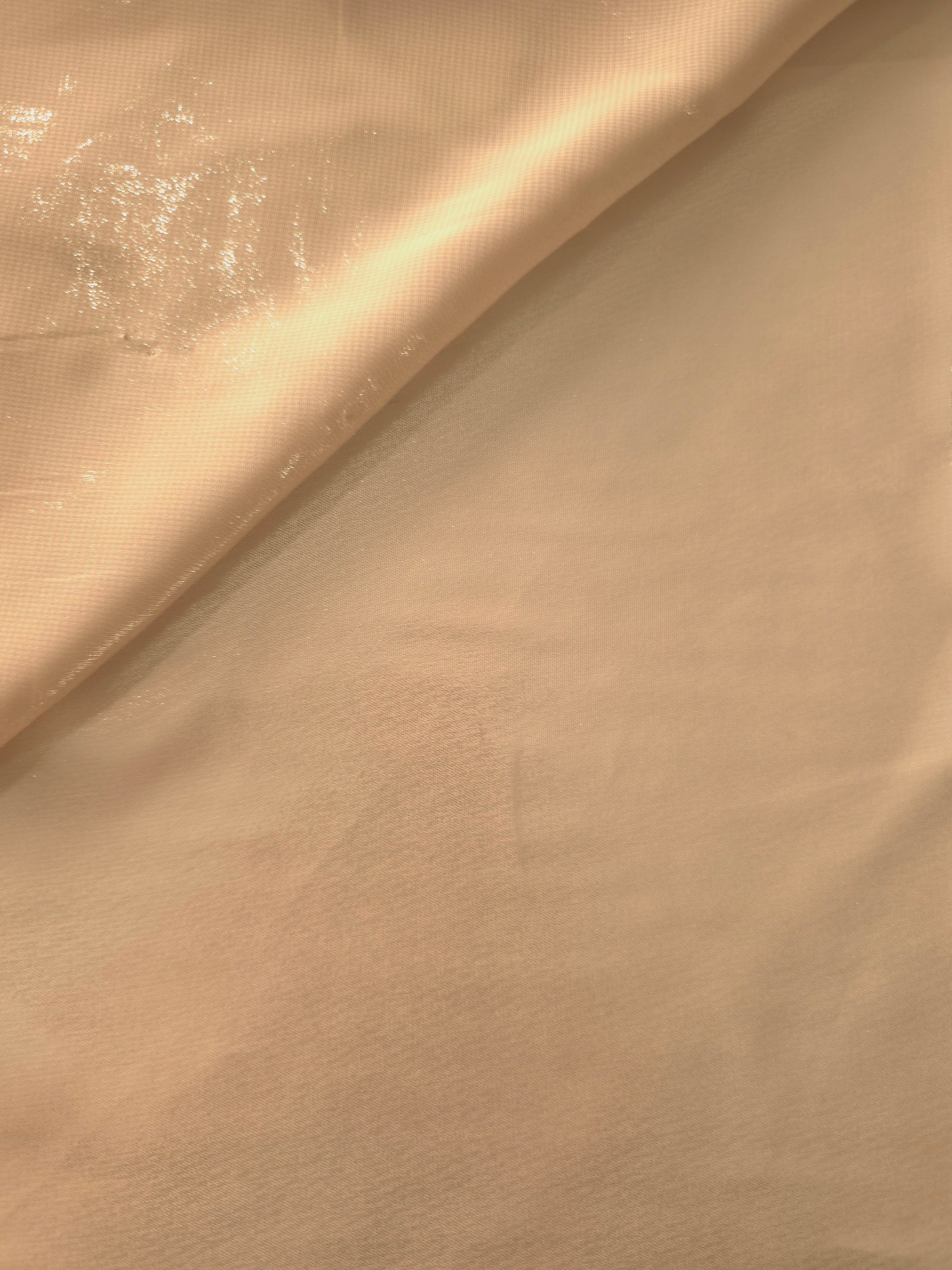 Soft taupe soft draping of liquid metallic shimmer chiffon fabric, showing lightweight reflective fabric texture and drape