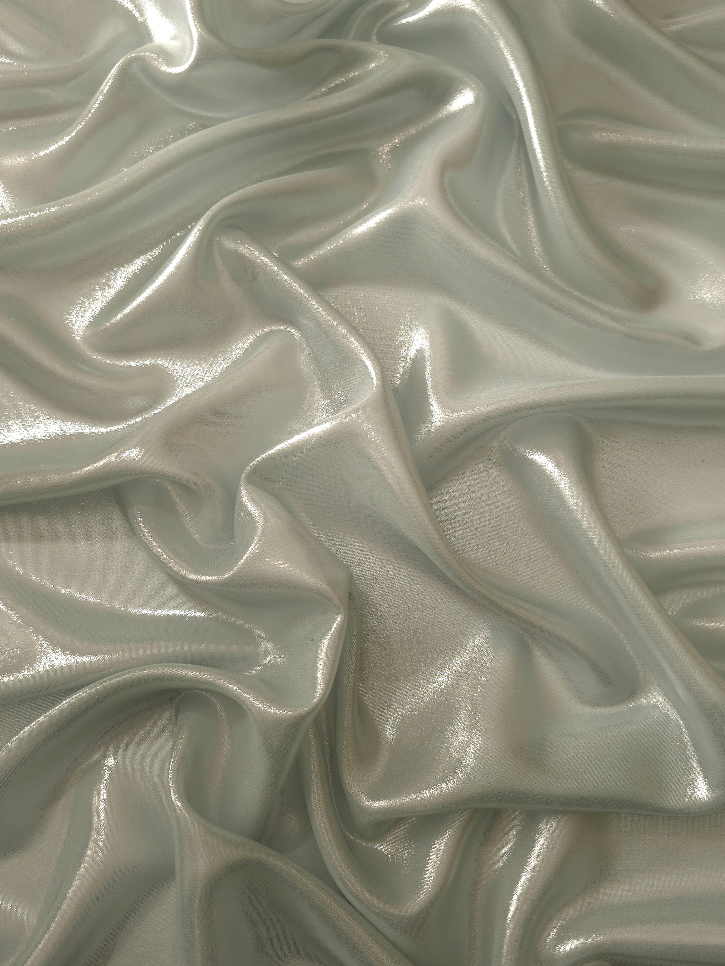 Stone greige surface detail of liquid metallic shimmer chiffon fabric, showing lightweight reflective fabric texture and drape