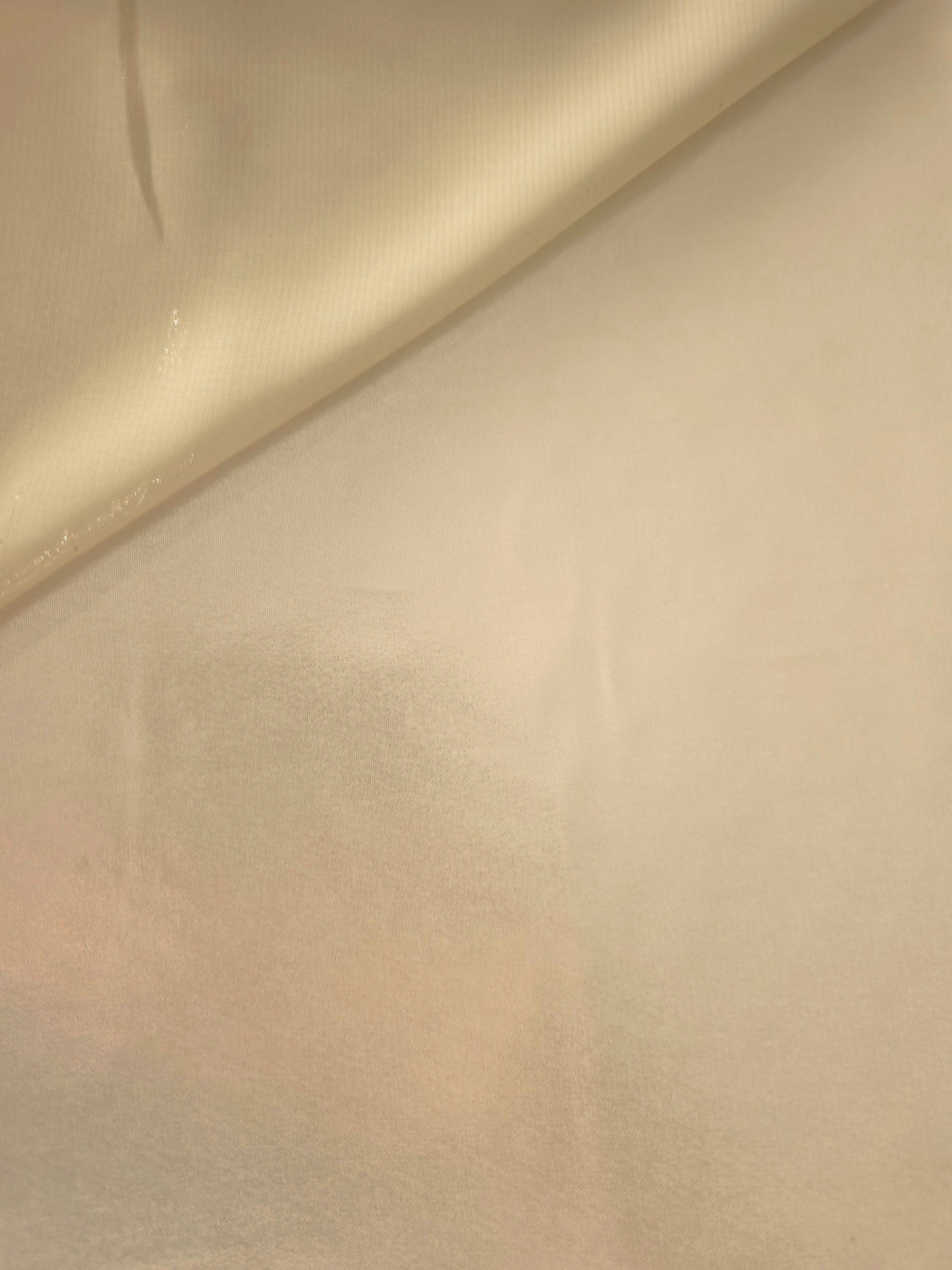 Warm ivory soft draping of liquid metallic shimmer chiffon fabric, showing lightweight reflective fabric texture and drape