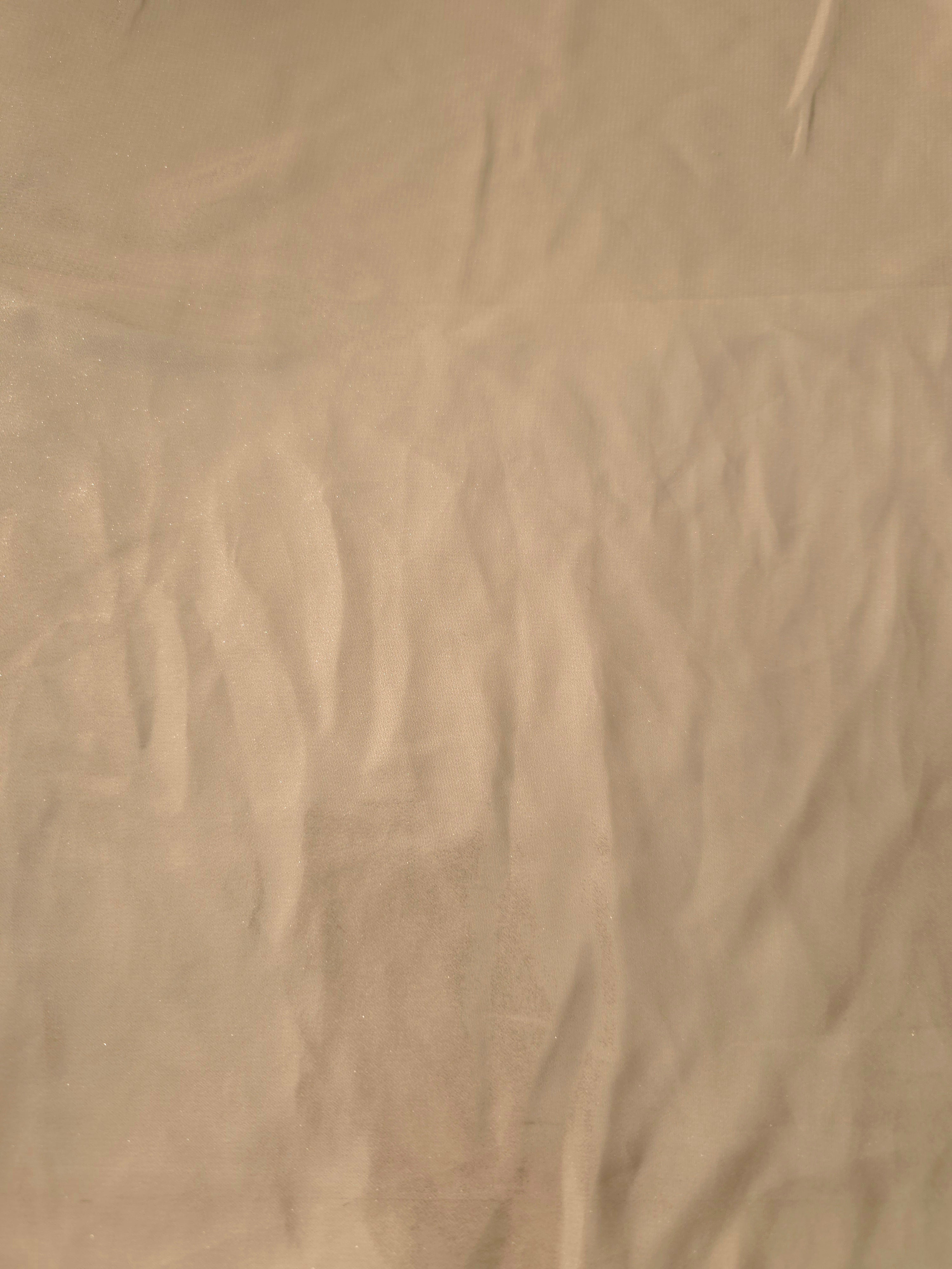 Warm sand fabric overview of liquid metallic shimmer chiffon fabric, showing lightweight reflective fabric texture and drape