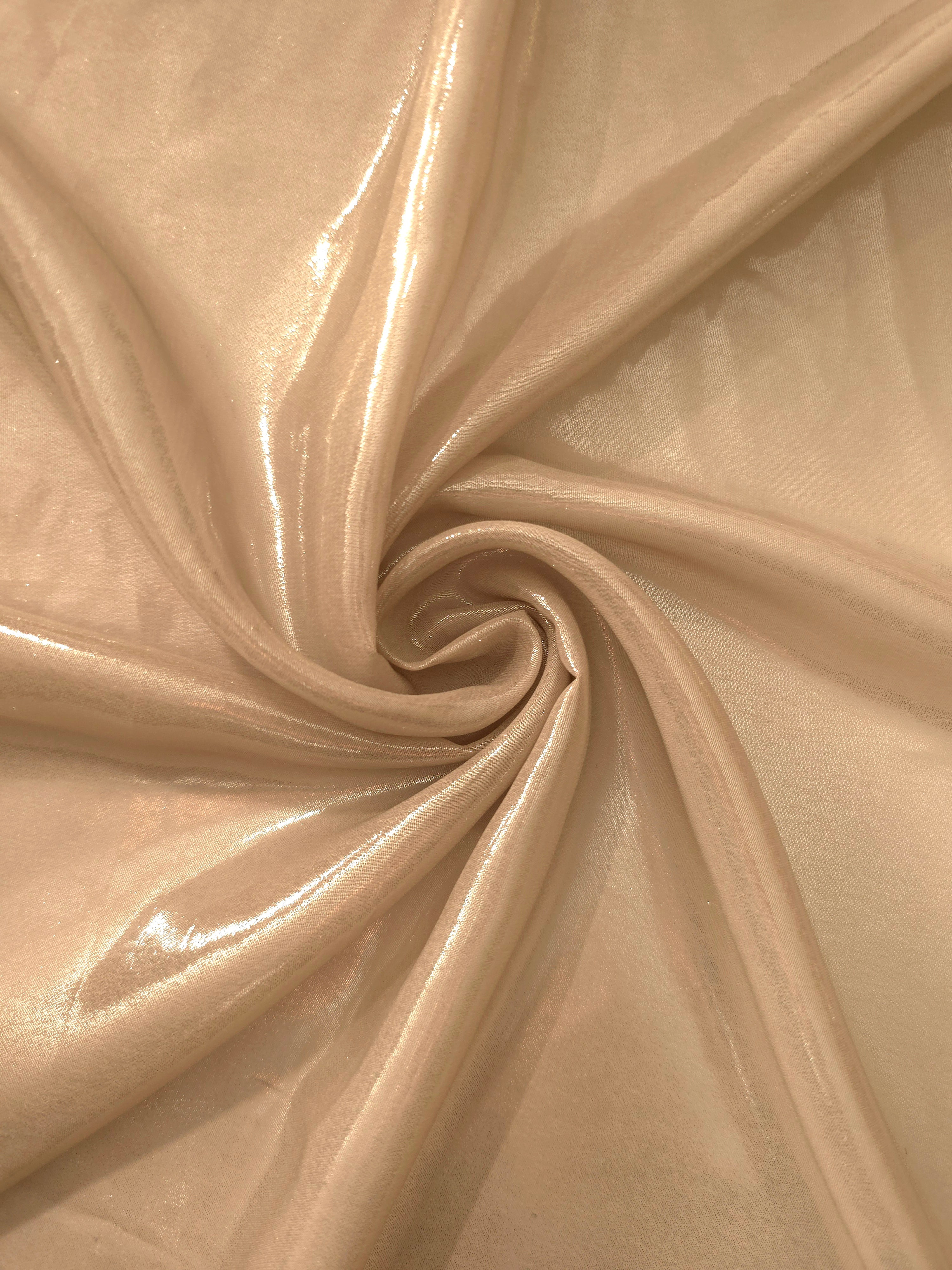 Warm sand shimmer close-up of liquid metallic shimmer chiffon fabric, showing lightweight reflective fabric texture and drape