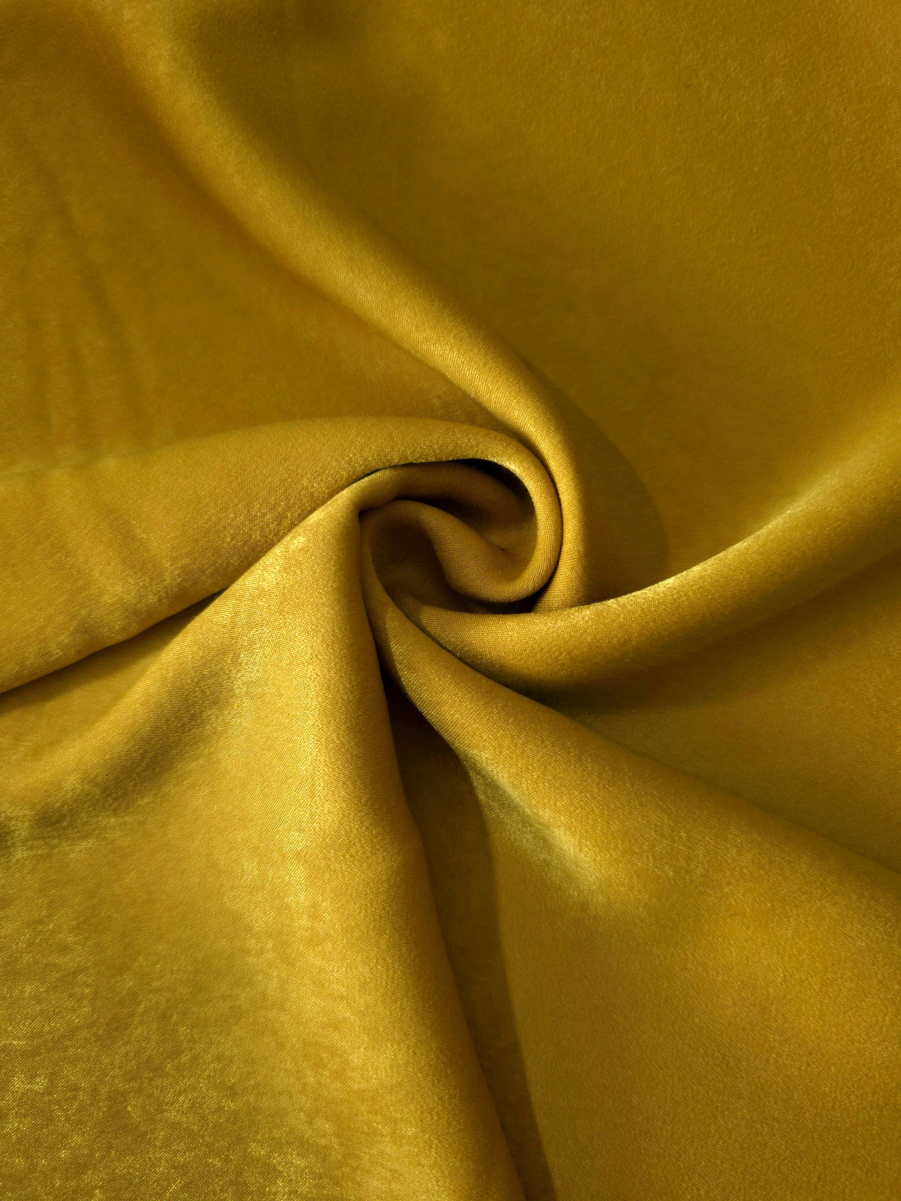 Mustard Yellow sandwashed polyamide fabric showing a soft folded drape