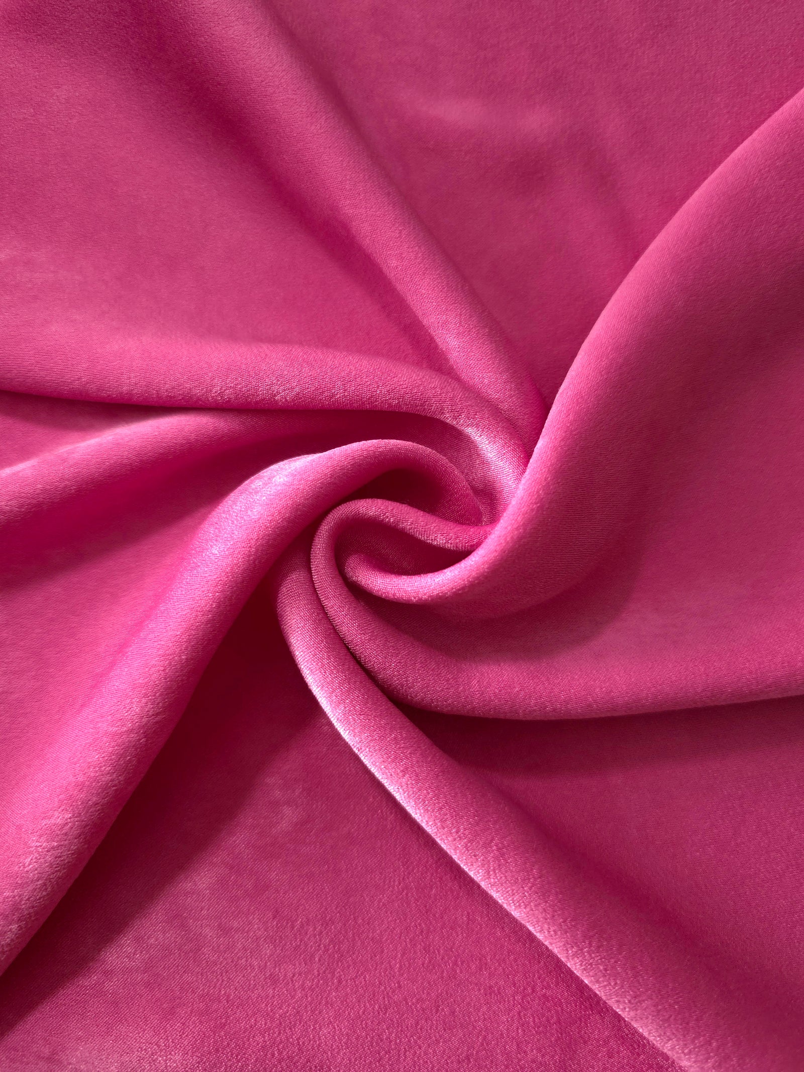 Raspberry Pink sandwashed polyamide fabric showing a soft folded drape