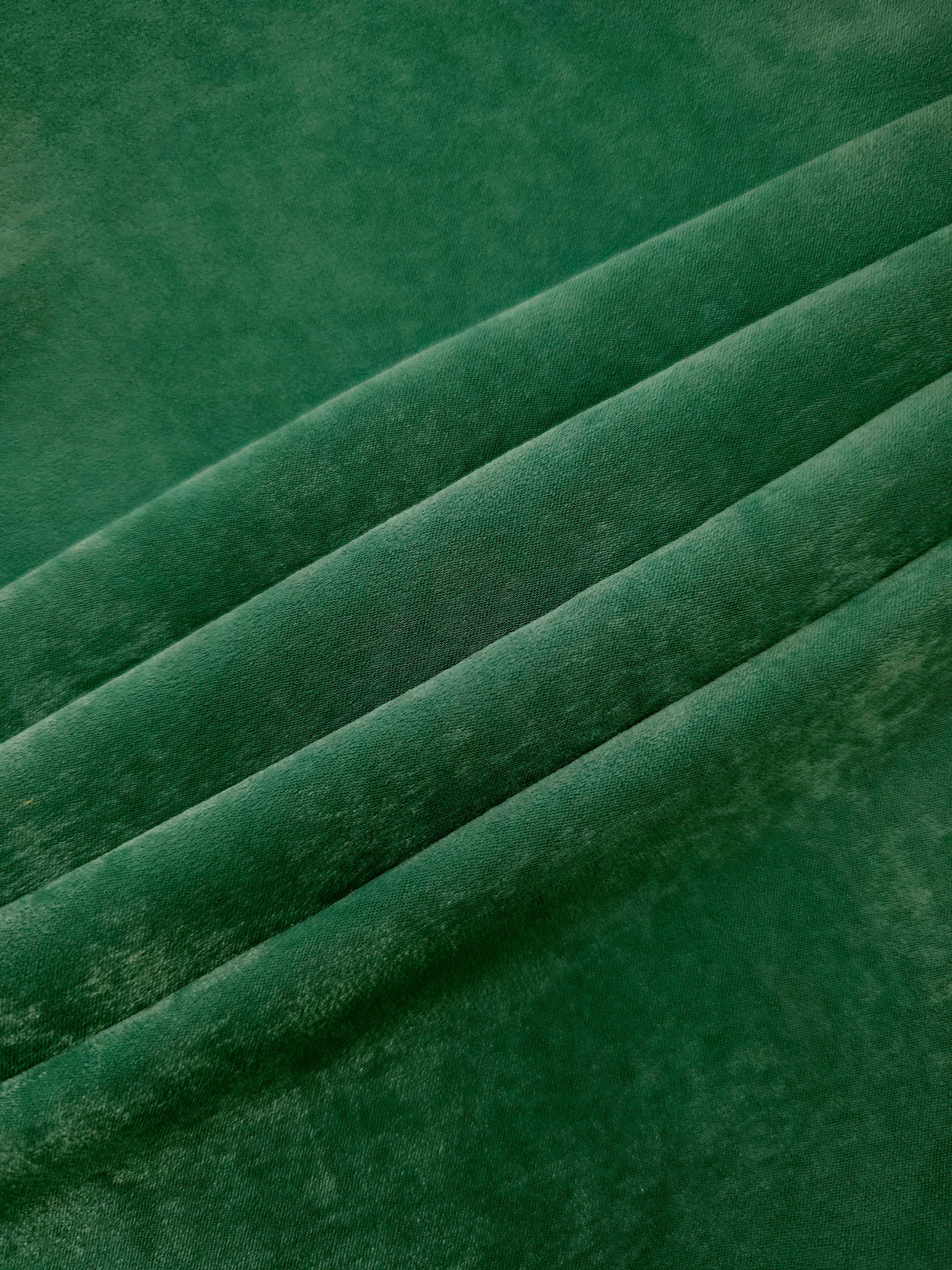 Emerald Green sandwashed polyamide fabric showing a soft folded drape