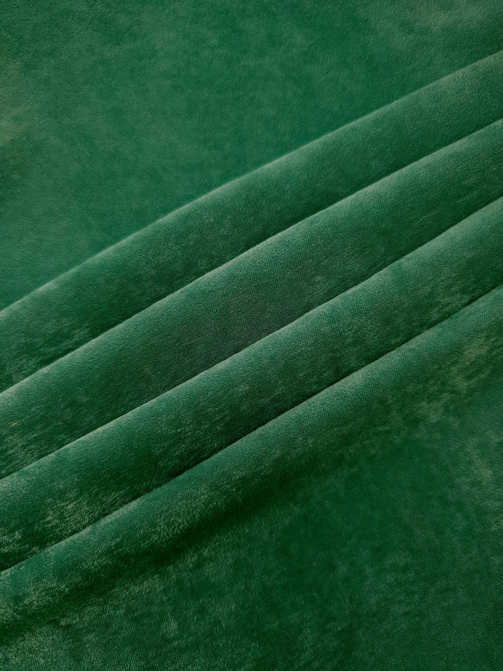 Emerald Green sandwashed polyamide fabric showing a soft folded drape