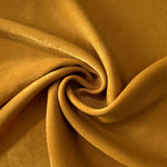 Golden Brown sandwashed polyamide fabric showing a soft folded drape