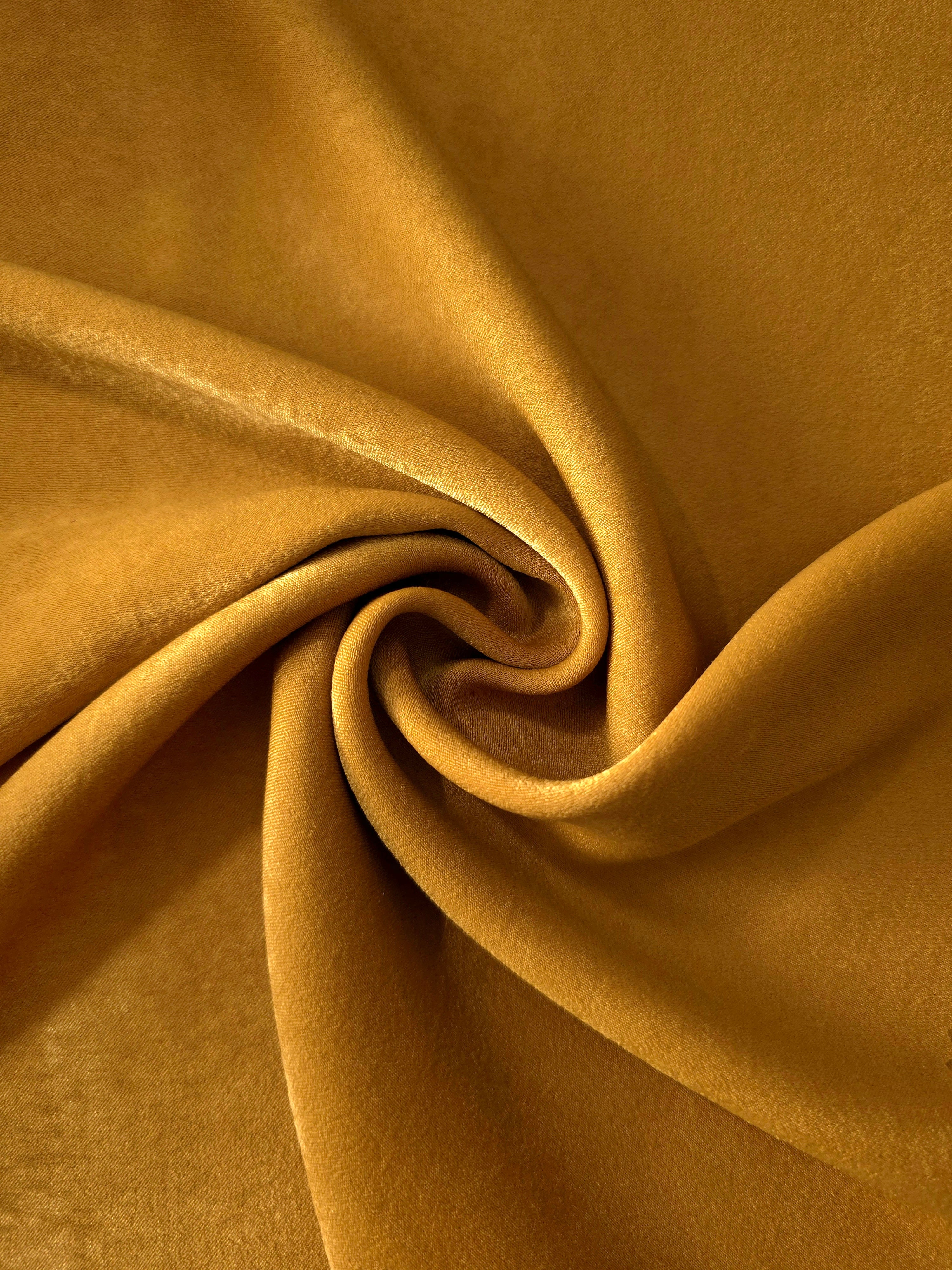 Golden Brown sandwashed polyamide fabric showing a soft folded drape