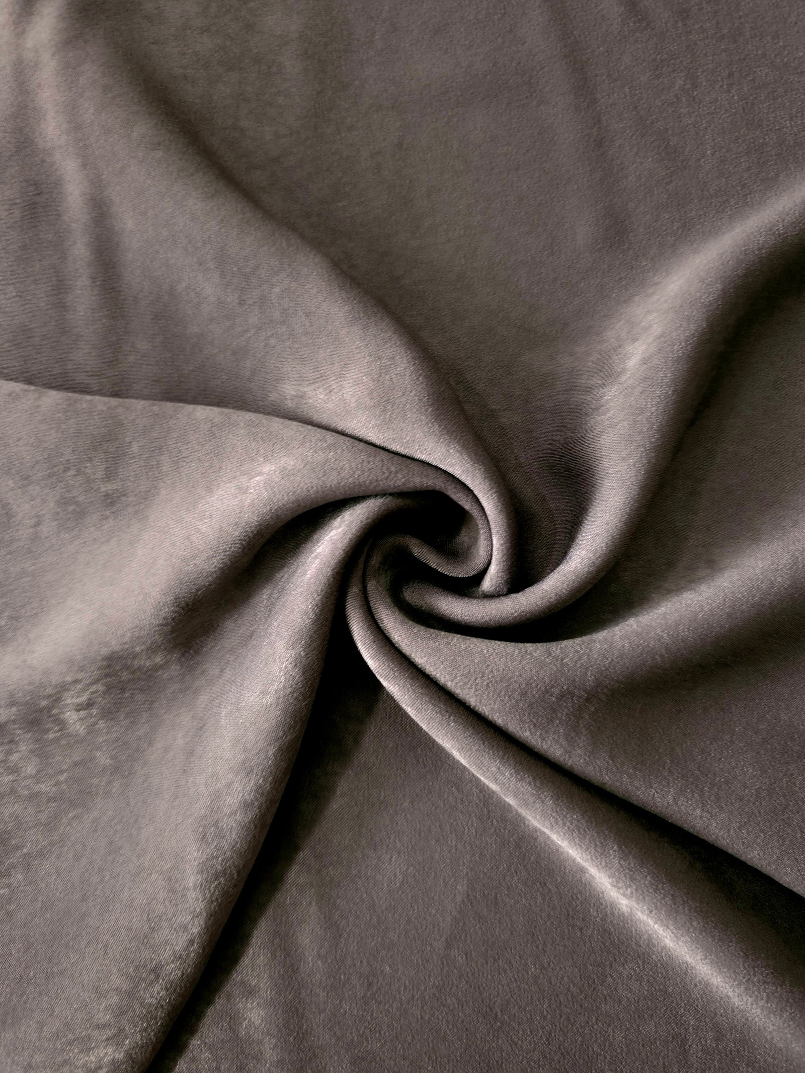 Smoked Charcoal sandwashed polyamide fabric showing a soft folded drape