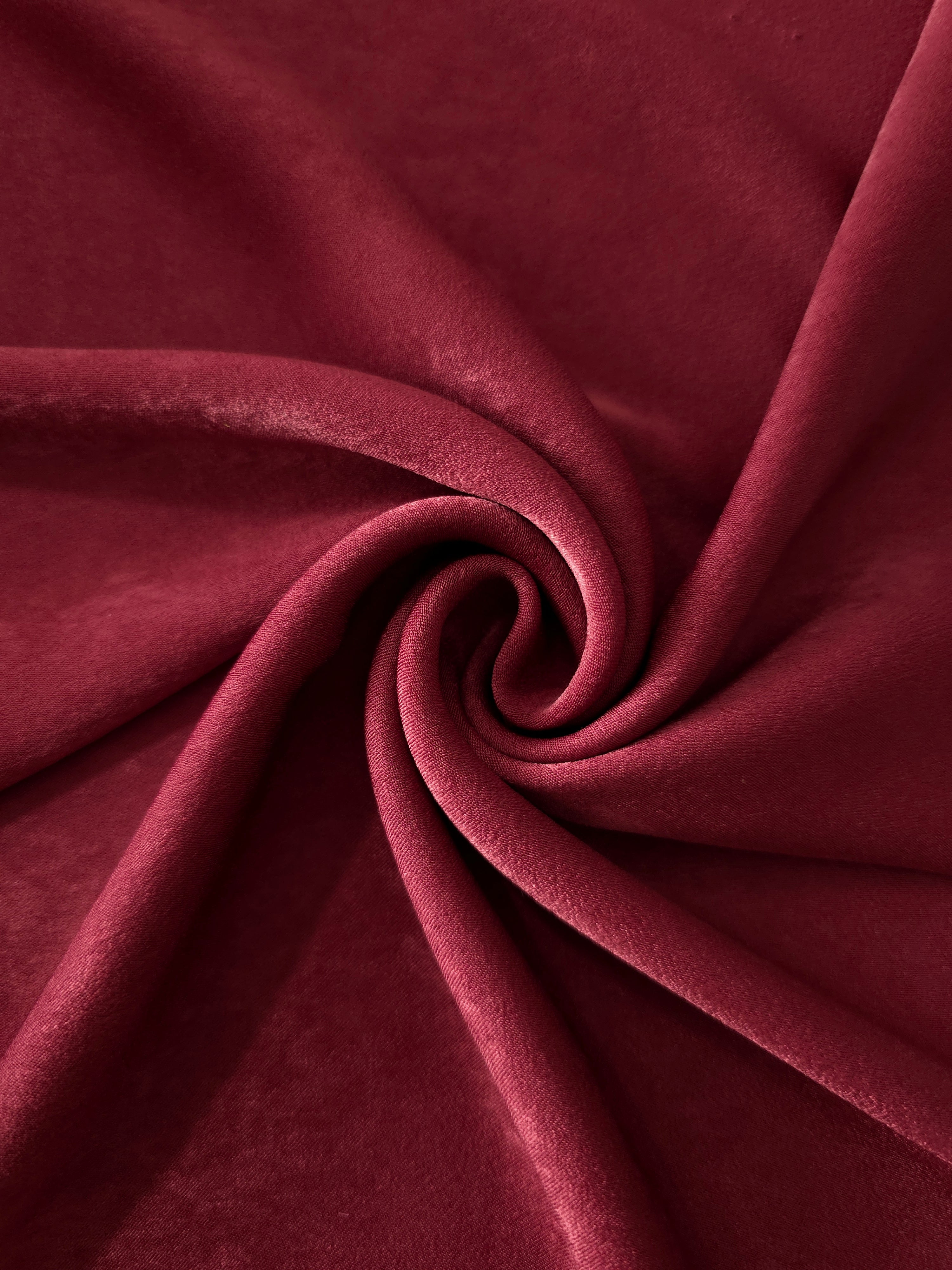 Deep Burgundy sandwashed polyamide fabric showing a soft folded drape