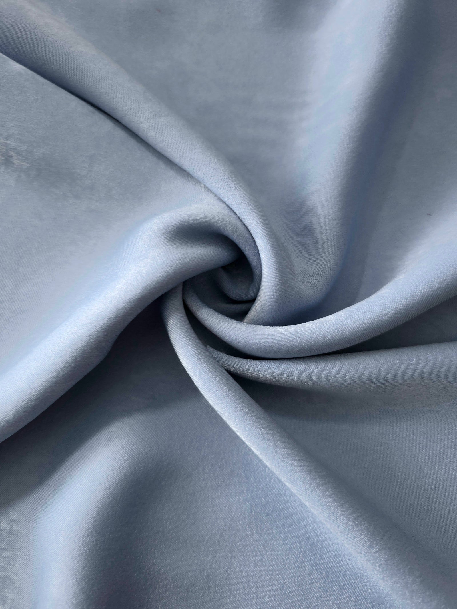 Silver Blue sandwashed polyamide fabric showing a soft folded drape