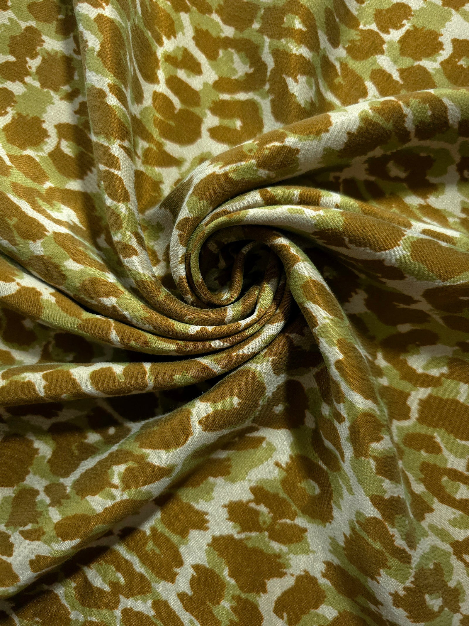 Swirl drape view of Bej D7586IJ4 leopard lyocell viscose digital print fabric.