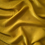 Matte silky sandwashed polyamide fabric in Mustard Yellow for dresses and apparel