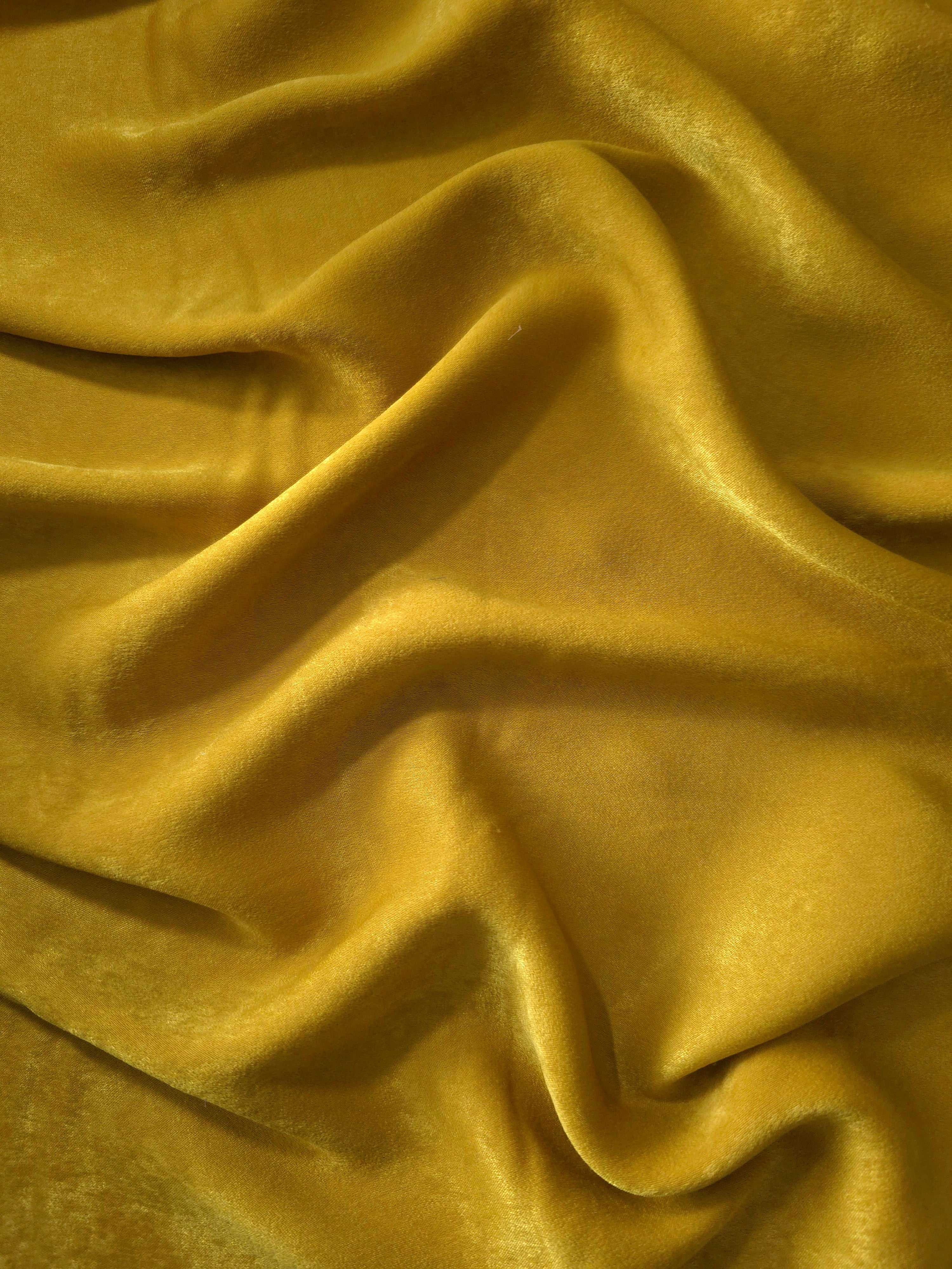Matte silky sandwashed polyamide fabric in Mustard Yellow for dresses and apparel