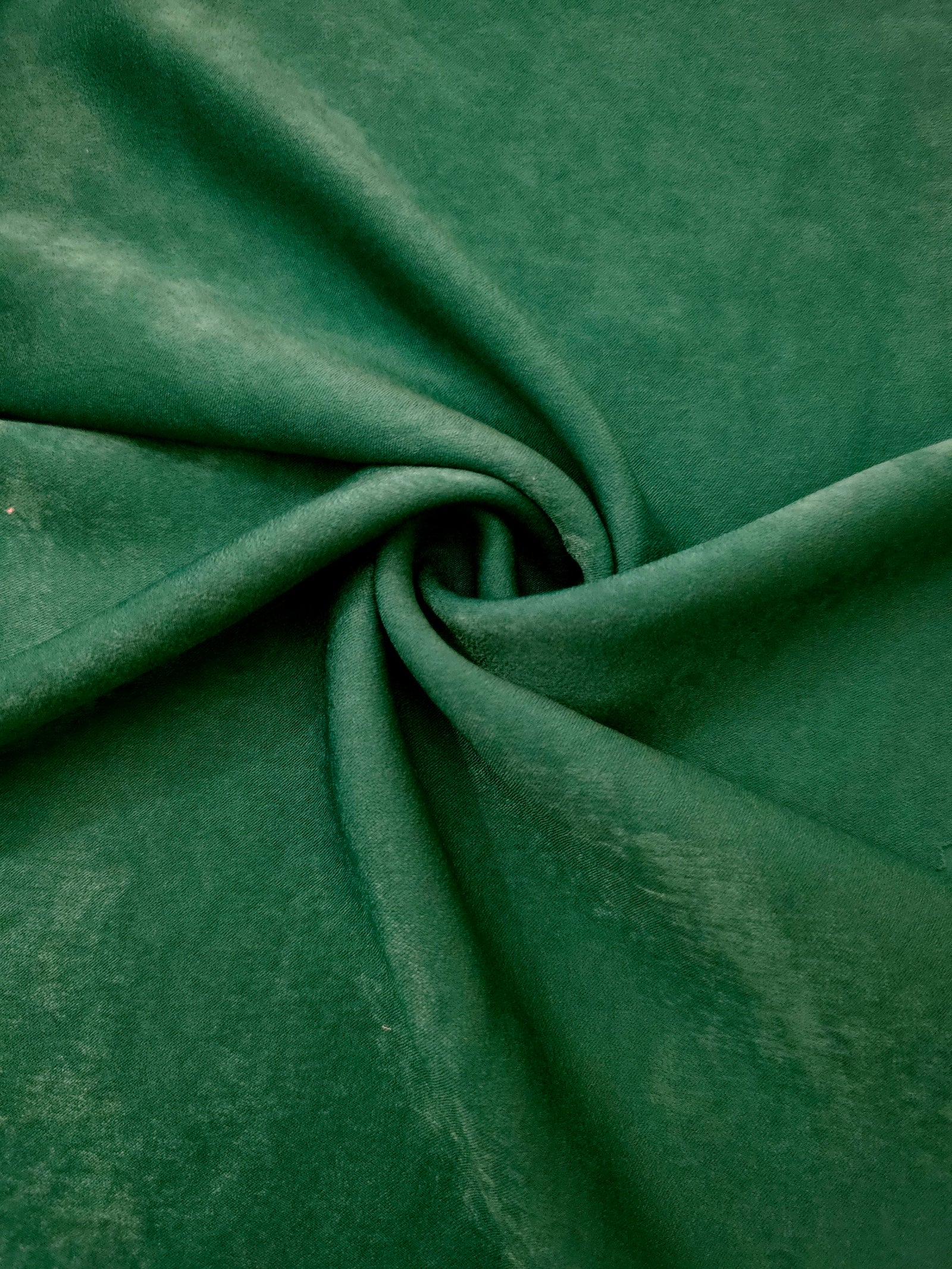 Matte silky sandwashed polyamide fabric in Emerald Green for dresses and apparel