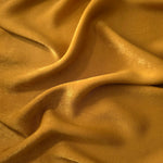 Matte silky sandwashed polyamide fabric in Golden Brown for dresses and apparel