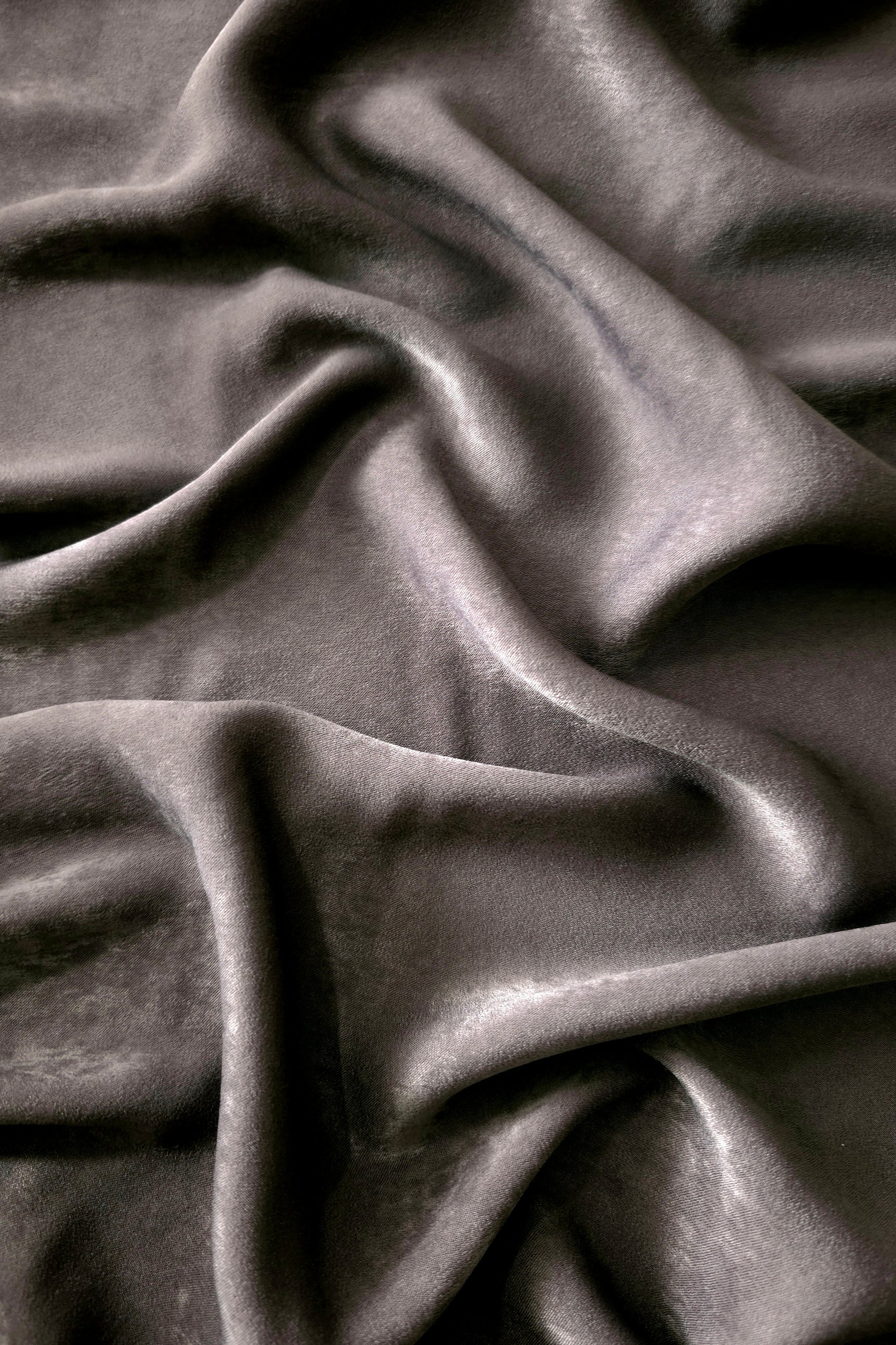 Matte silky sandwashed polyamide fabric in Smoked Charcoal for dresses and apparel