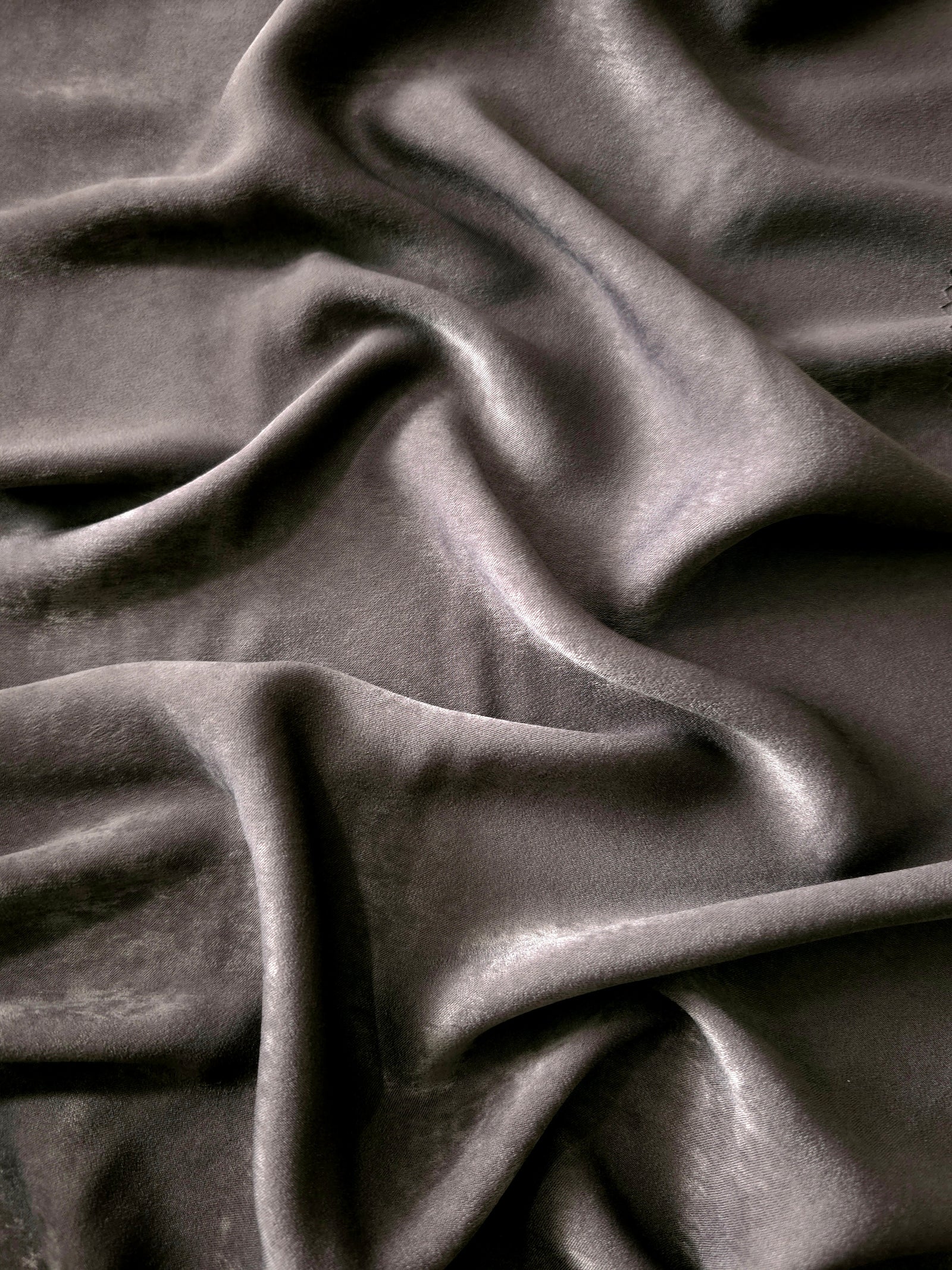 Matte silky sandwashed polyamide fabric in Smoked Charcoal for dresses and apparel