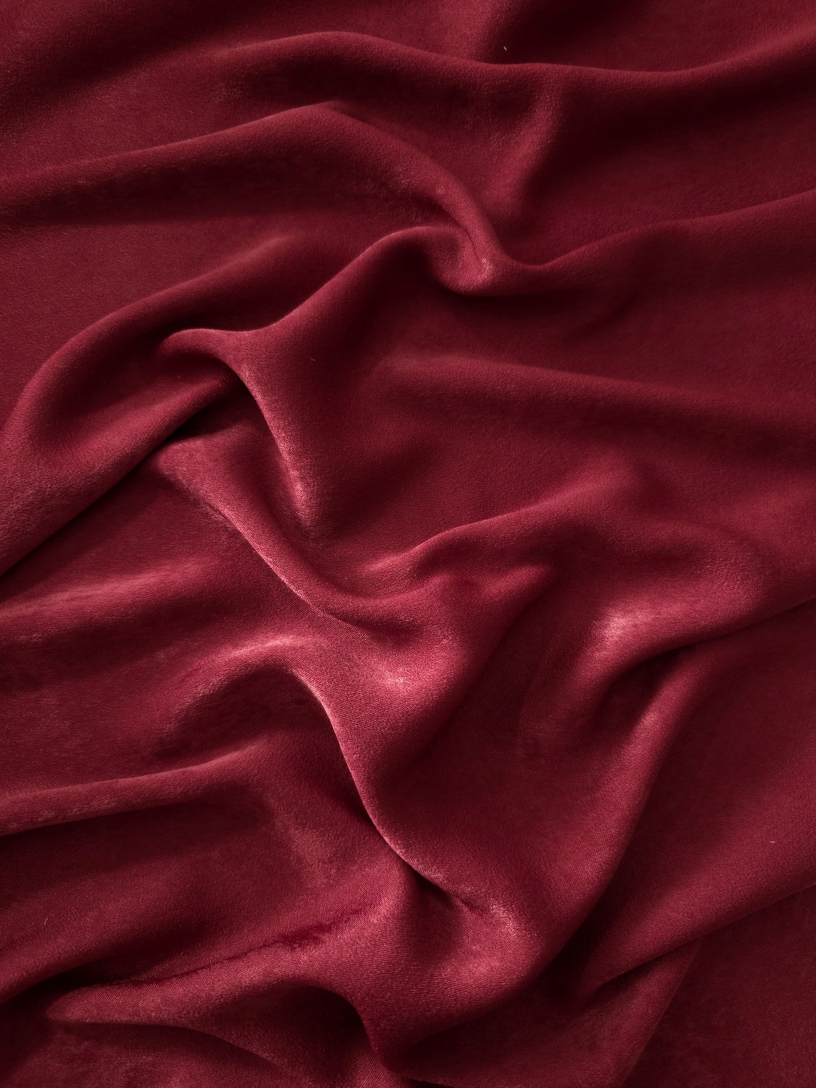 Matte silky sandwashed polyamide fabric in Deep Burgundy for dresses and apparel