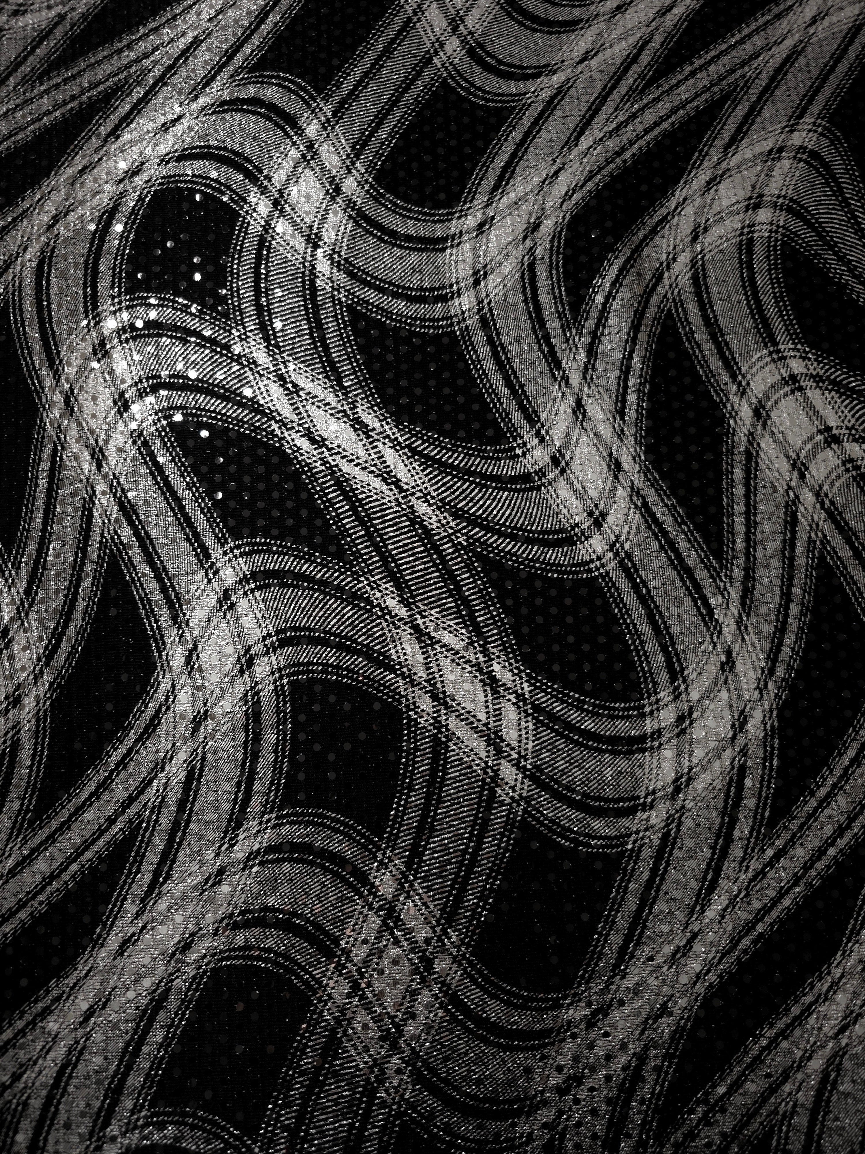 Macro-style view of Silver Gray Fluid Waves metallic sequin tulle shows layered sparkle and fine black mesh for special-occasion dresses, sleeves and decorative panels.