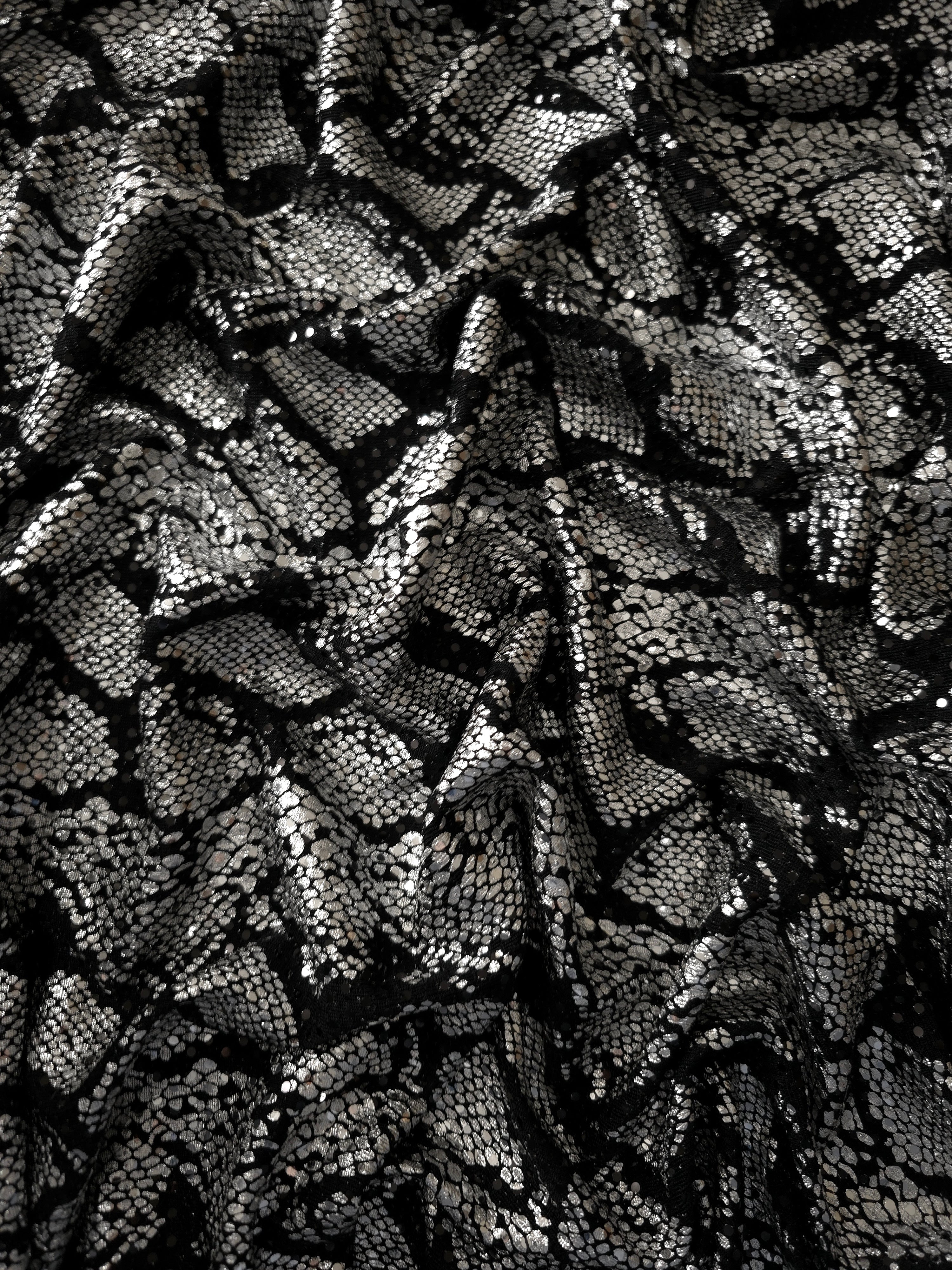 Softly draped Silver Gray Metallic Python foil sequin mesh, combining a dark sheer base with reflective surface detail for partywear, fashion tops and theatrical costumes.