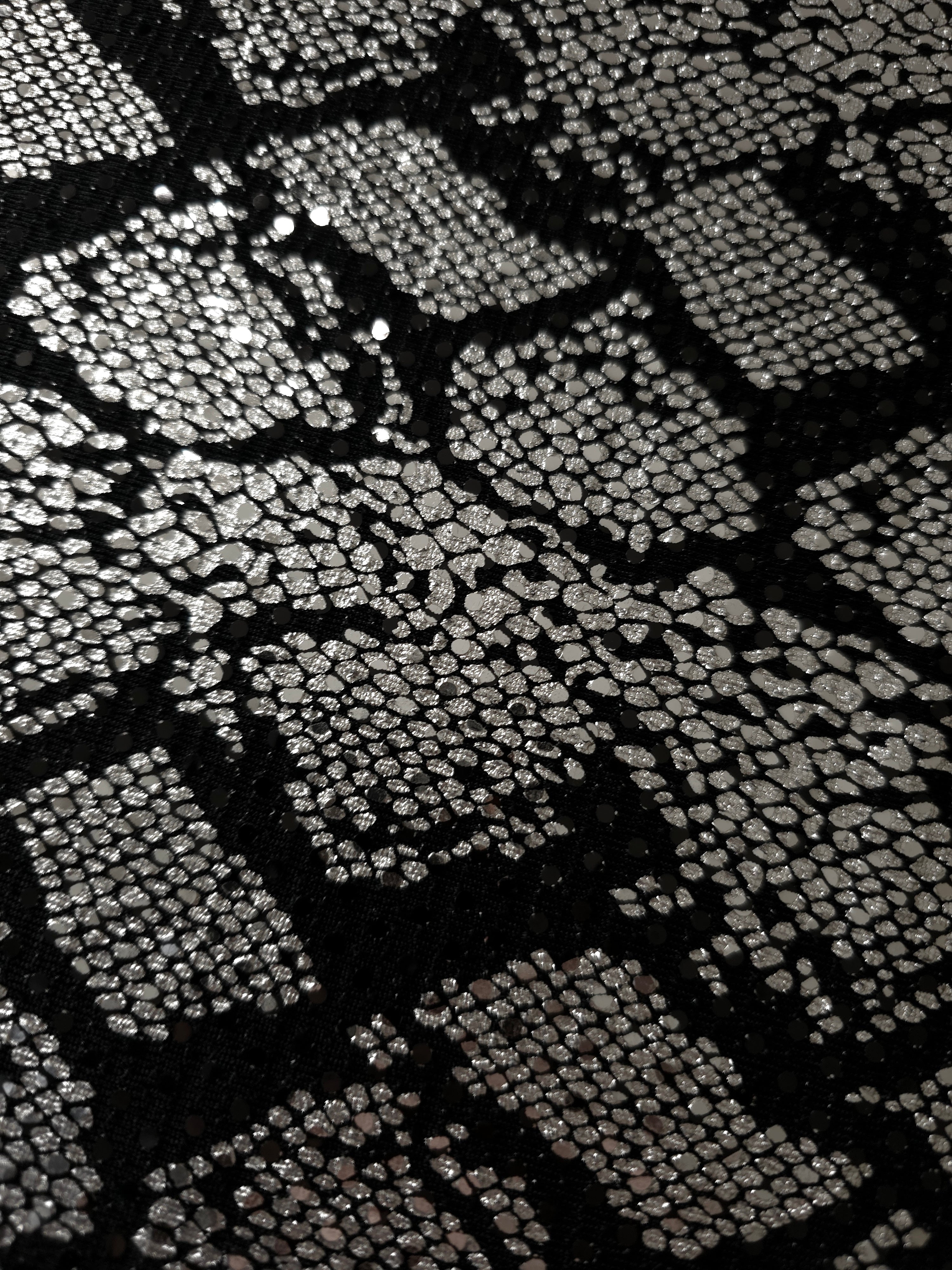 Detailed surface view of Silver Gray Metallic Python foil sequin mesh, showing reflective motifs across the dark sheer base for occasion skirts, bodice panels and stagewear.