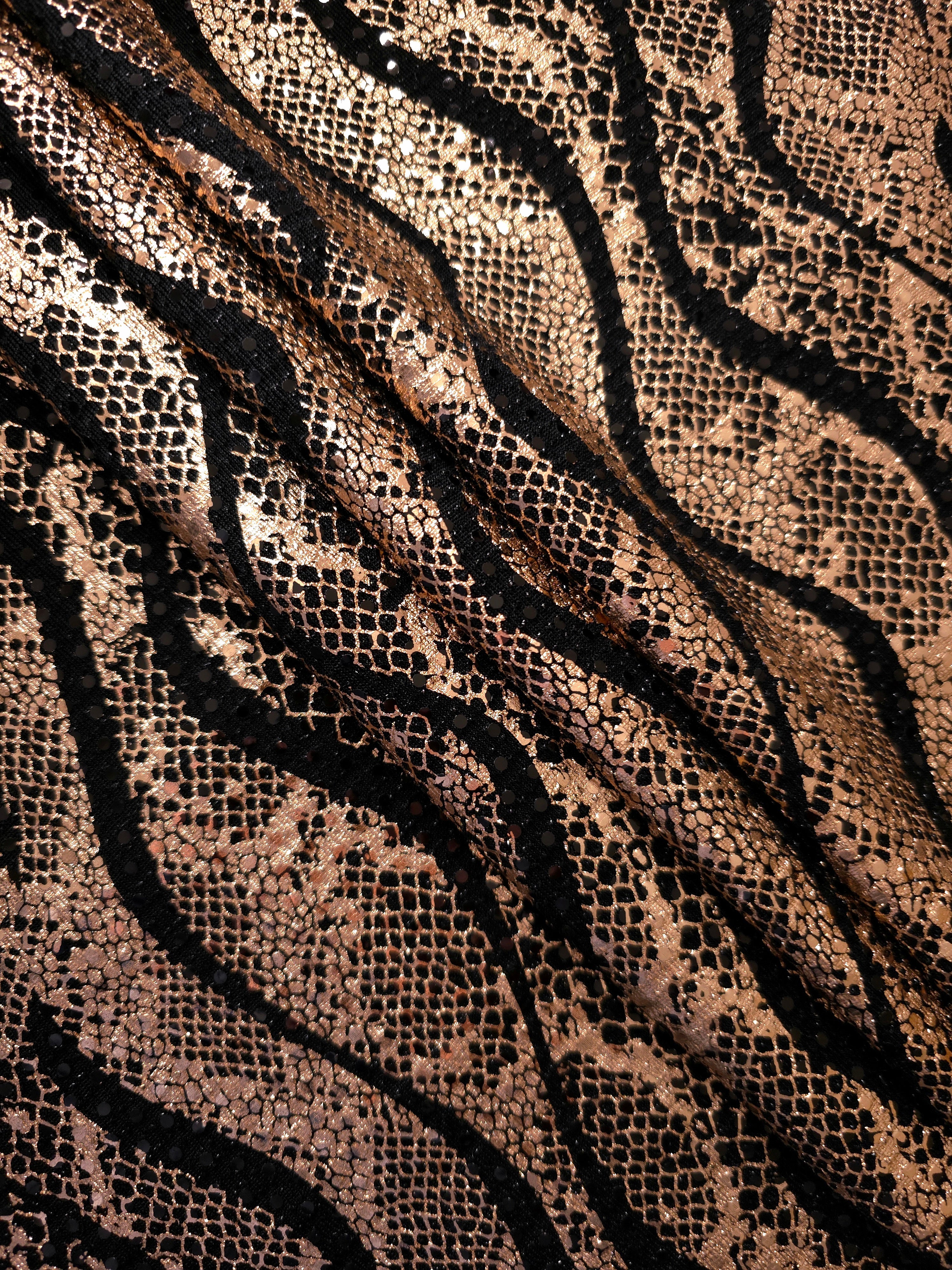 Relaxed folds in Rose Gold Wavy Python sequin tulle reveal reflective metallic patterning over the sheer black base for evening separates, sheer overlays and costume accents.