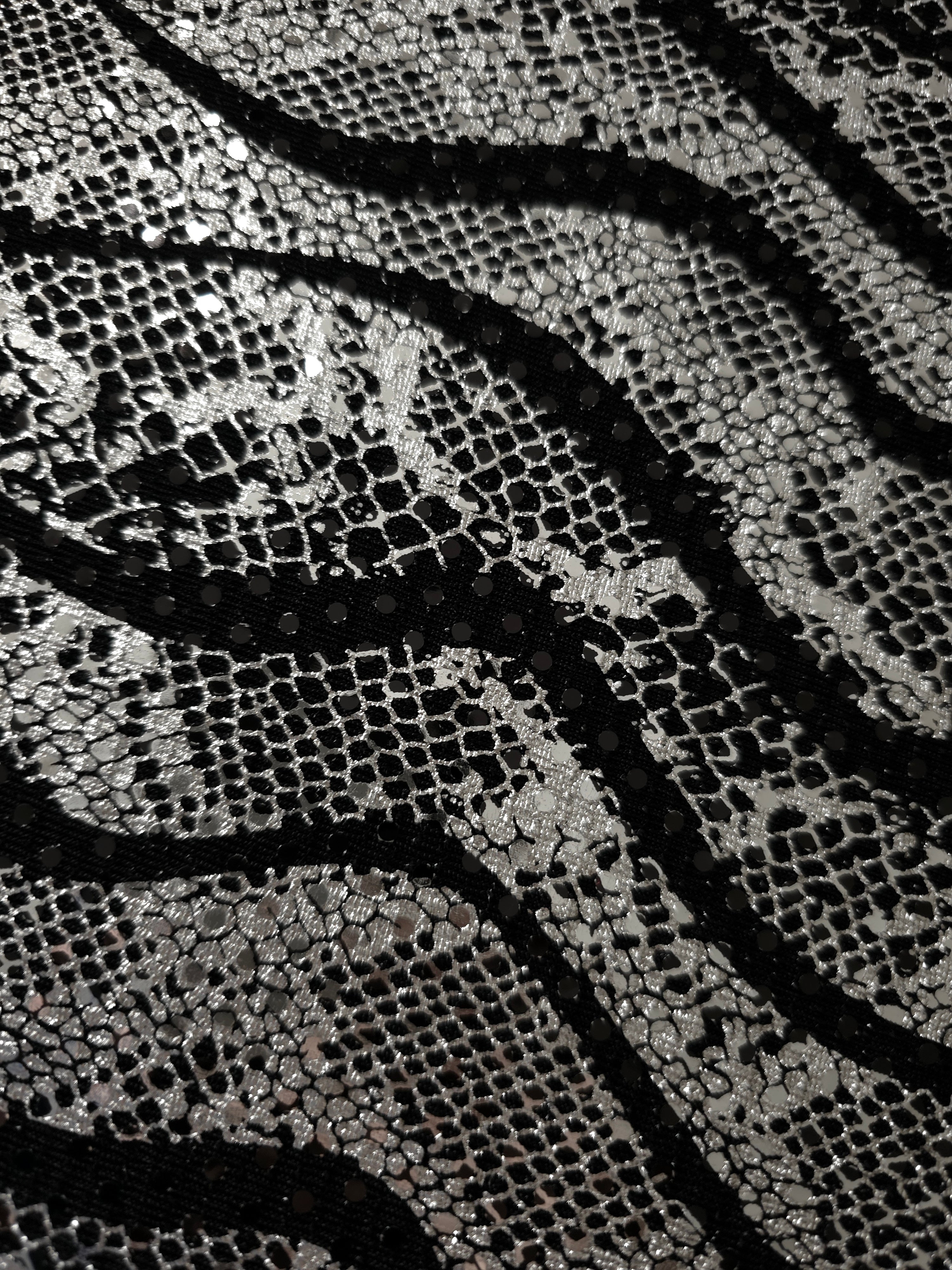 Surface view of Silver Gray Wavy Python sequin fabric shows metallic pattern definition and textured shine for prom gowns, statement sleeves and fashion accessories.