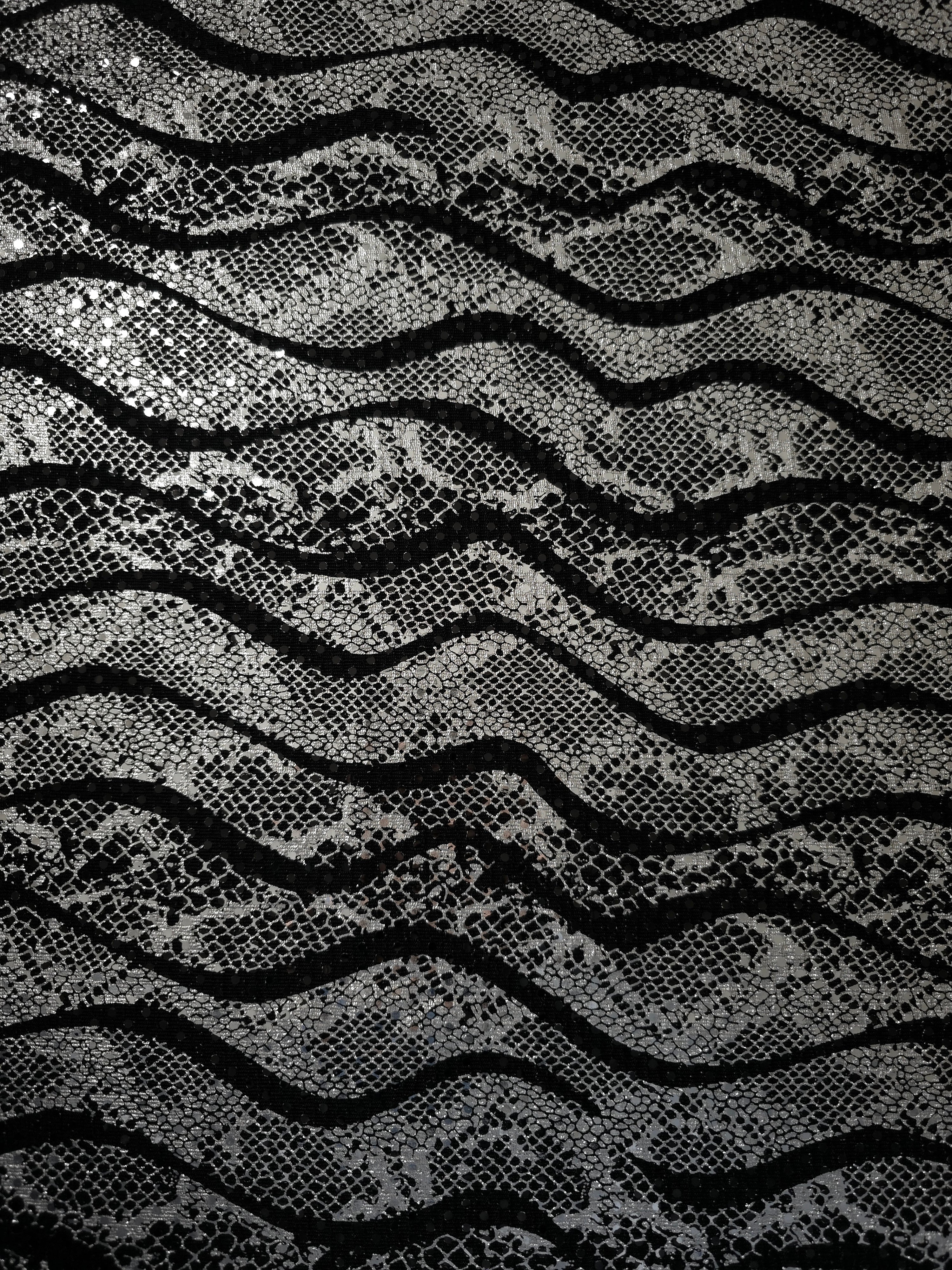 Close texture view of Silver Gray Wavy Python foil sequin fabric captures reflective accents and intricate surface pattern for cocktail dresses, event tops and decorative inserts.