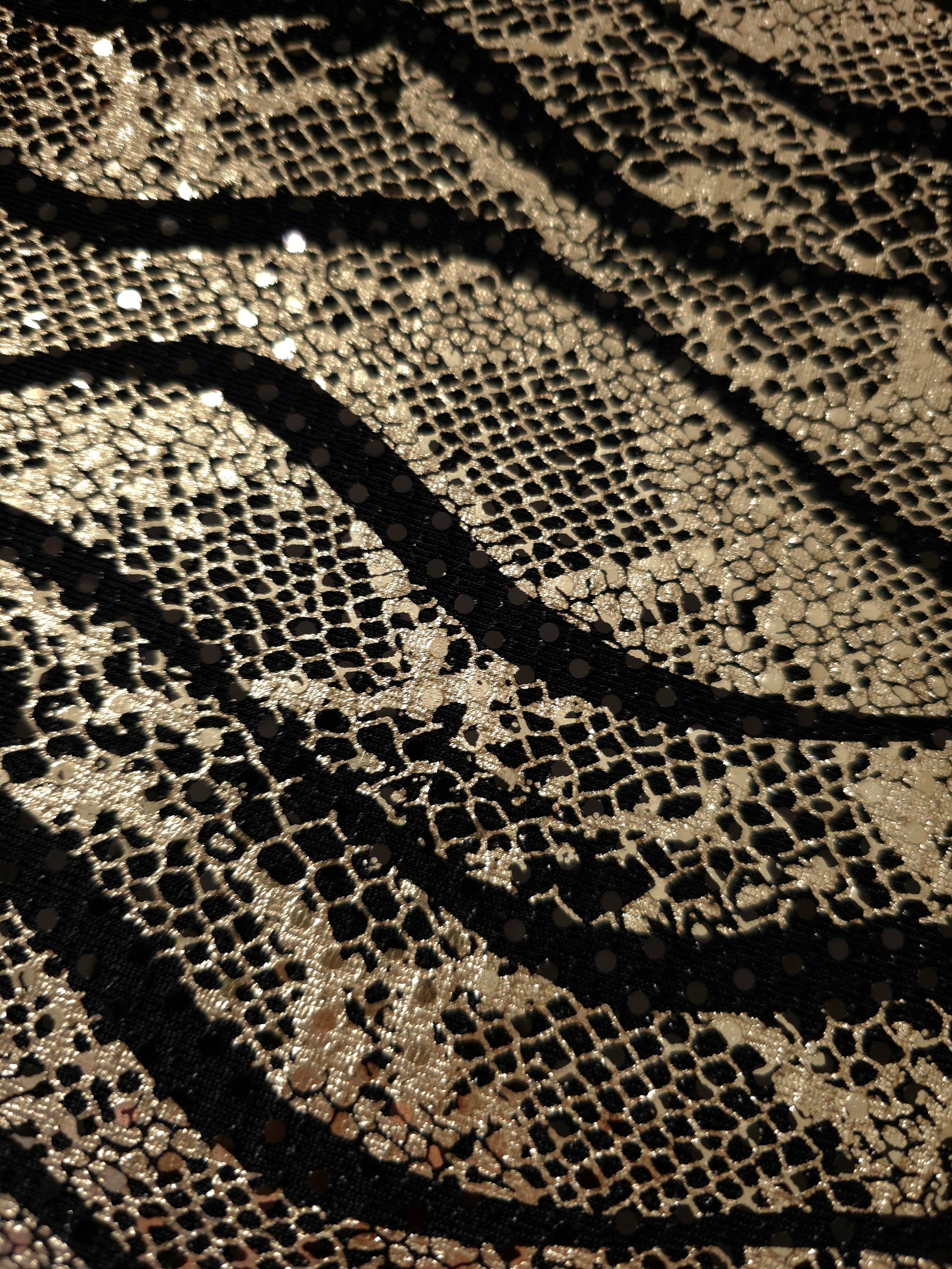 Surface view of Soft Gold Wavy Python sequin fabric shows metallic pattern definition and textured shine for prom gowns, statement sleeves and fashion accessories.