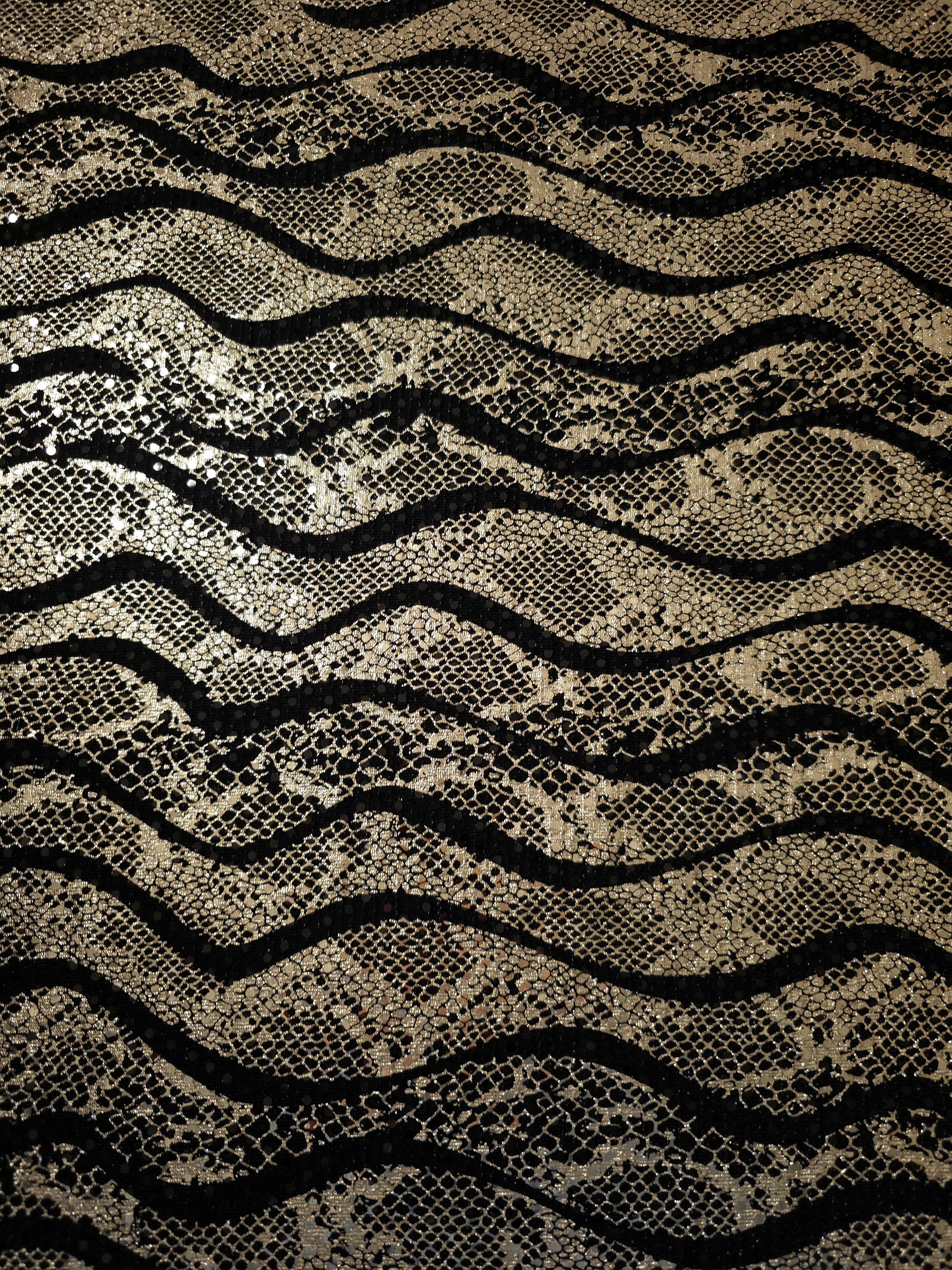 Close texture view of Soft Gold Wavy Python foil sequin fabric captures reflective accents and intricate surface pattern for cocktail dresses, event tops and decorative inserts.
