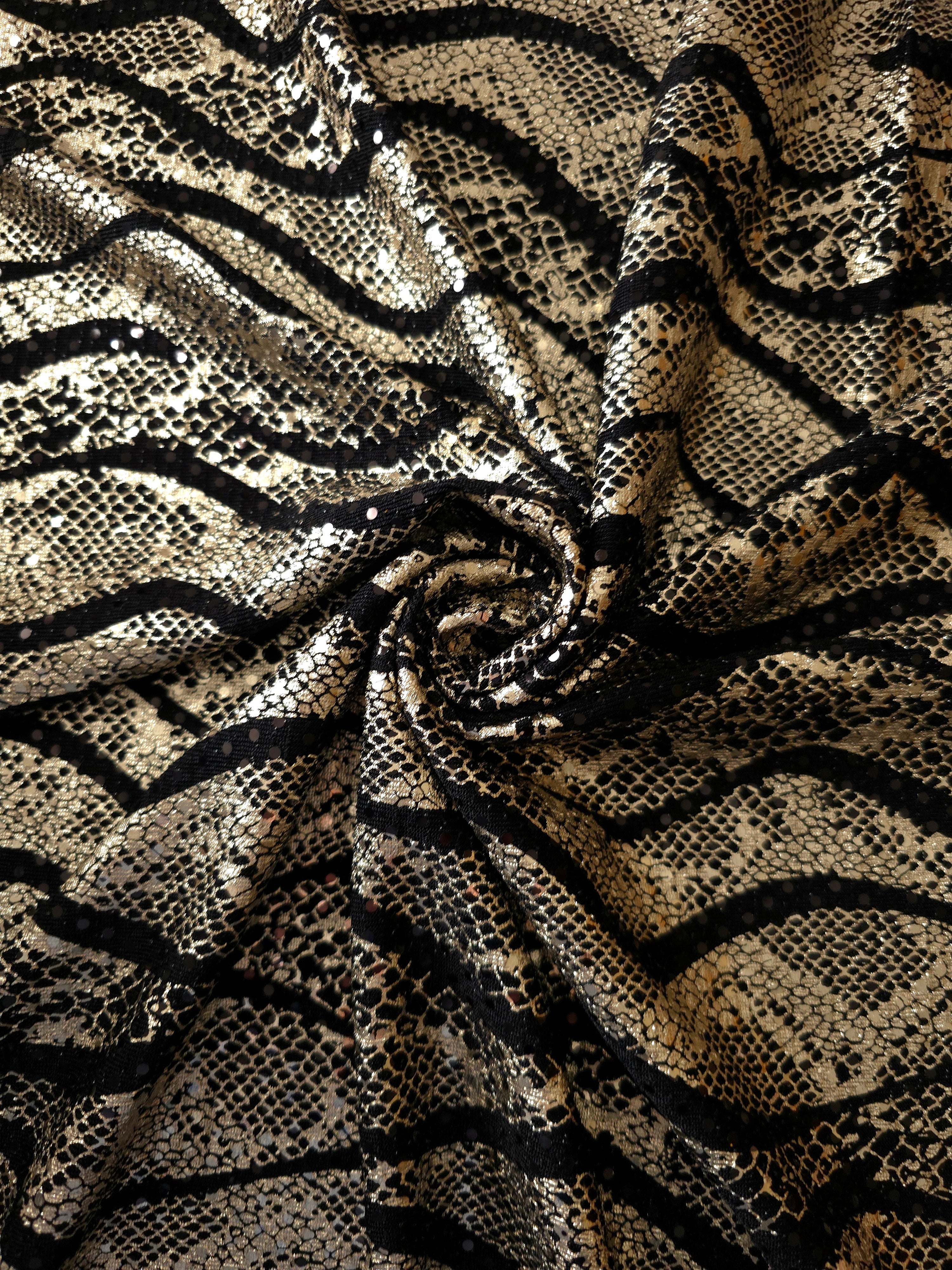 Sculpted twist of Soft Gold Wavy Python sequin fabric reveals metallic highlights and flowing black tulle underneath for special-occasion garments, performance pieces and overlays.