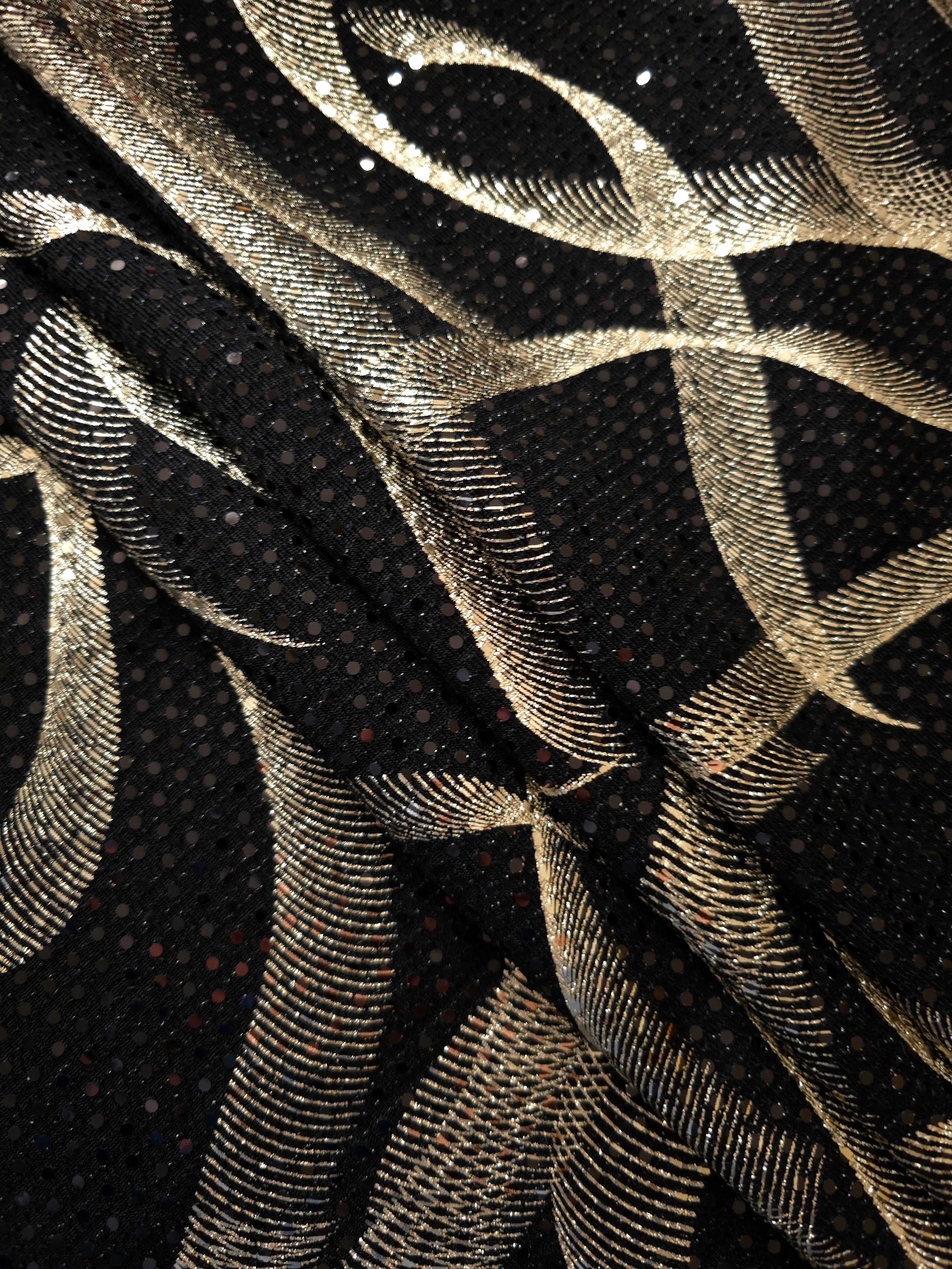 Softly gathered Soft Gold Abstract Ribbon metallic sequin fabric highlights drape, sparkle and dimensional surface detail for special-occasion dresses, sleeves and decorative panels.