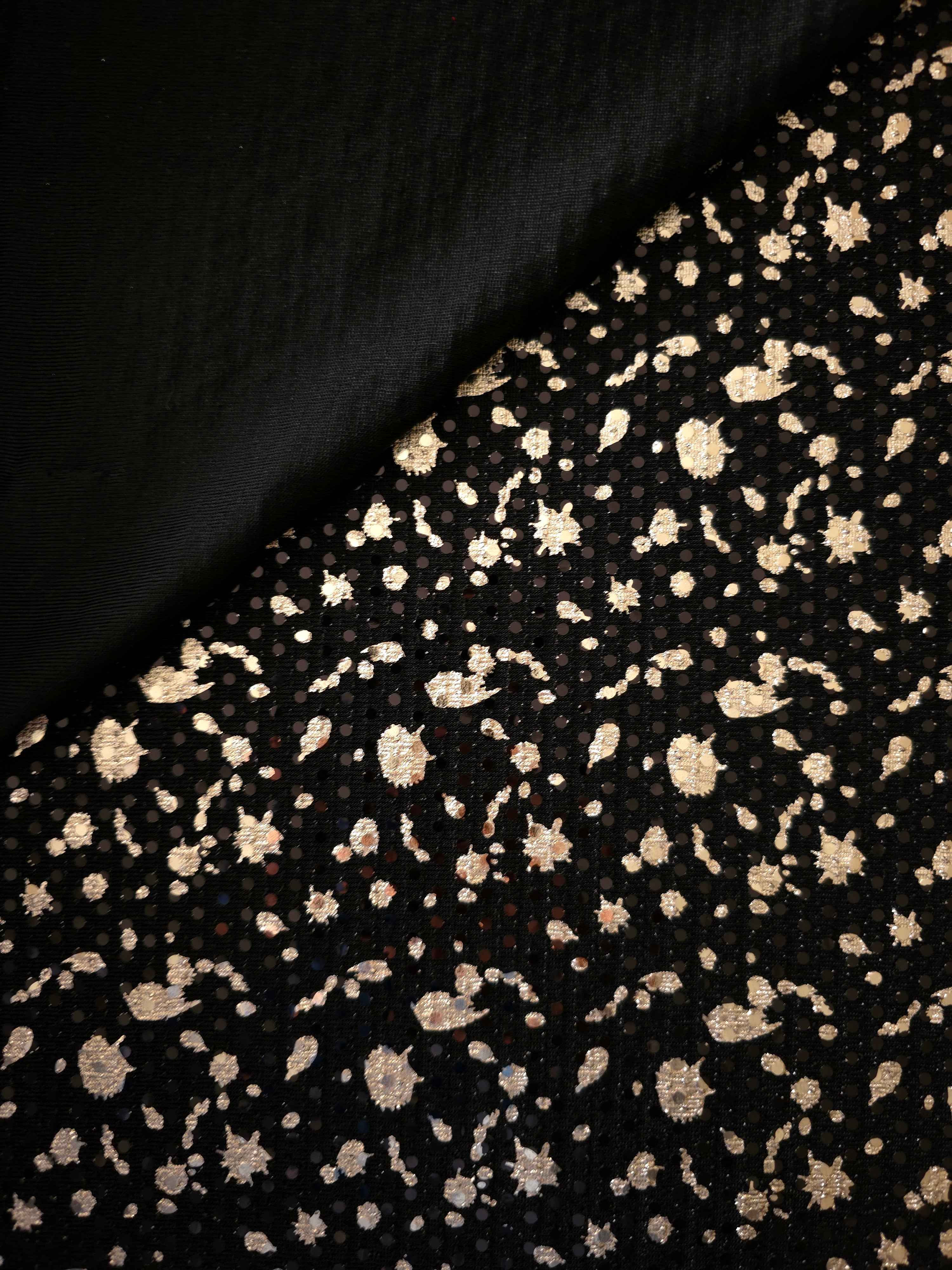 Layered folds in Soft Gold Cosmic Splatter metallic sequin tulle emphasize texture, sparkle and dimensional pattern for prom gowns, statement sleeves and fashion accessories.