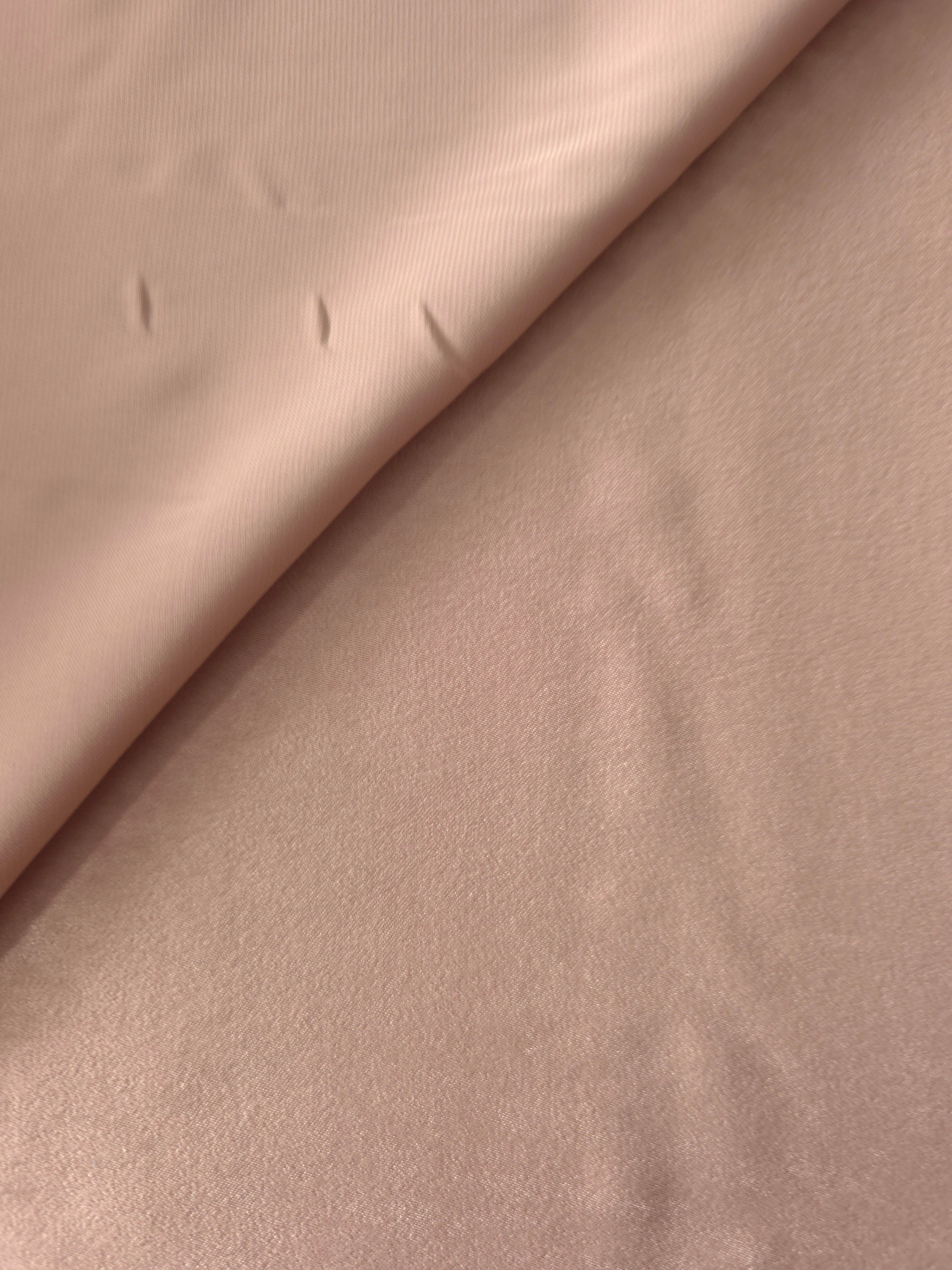Close-up of Blush Taupe Milano sandwashed silky fabric showing its smooth matte texture and soft surface