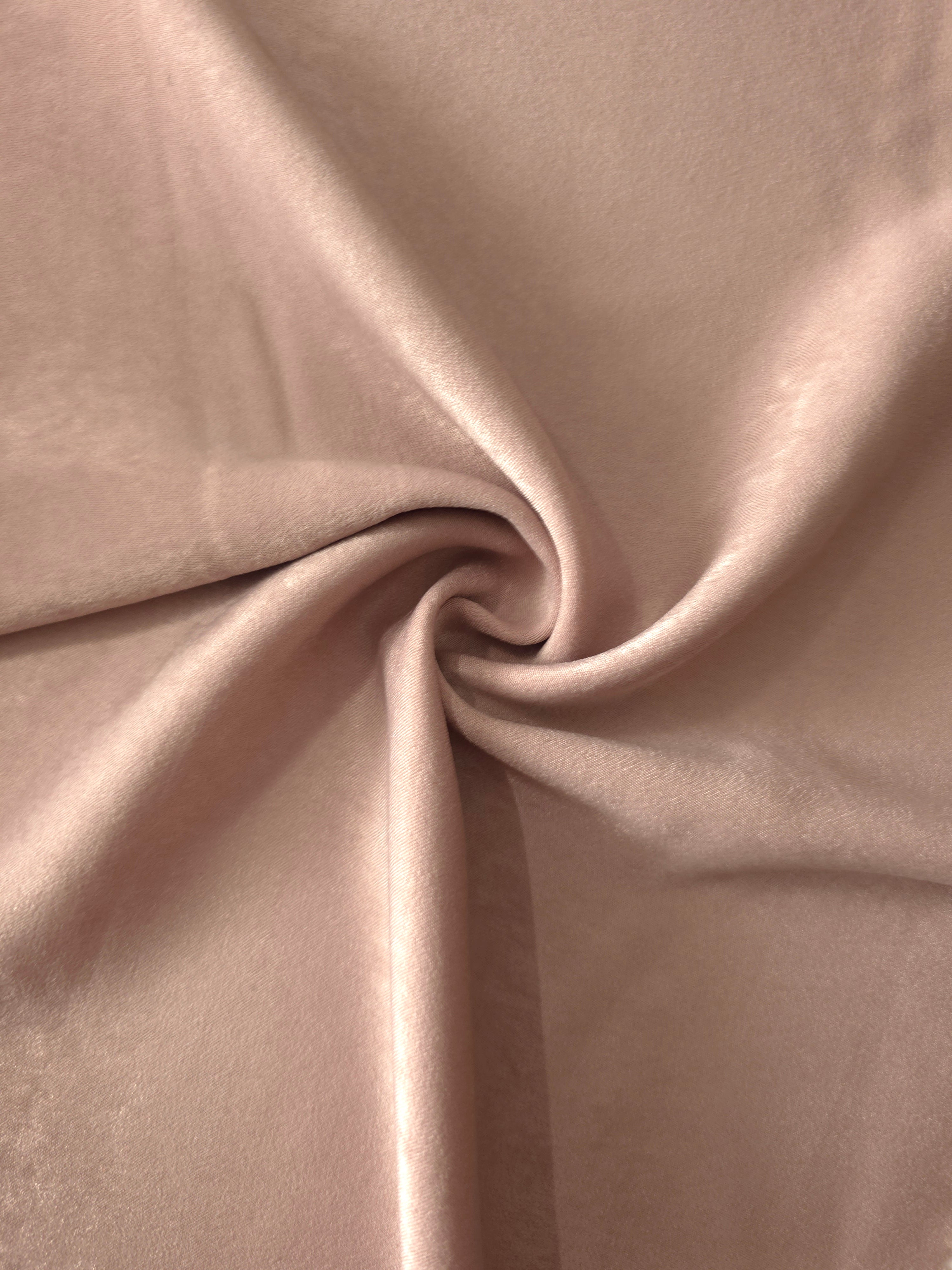 Soft folded detail of Blush Taupe Milano sandwashed silky fabric highlighting its matte finish and supple hand