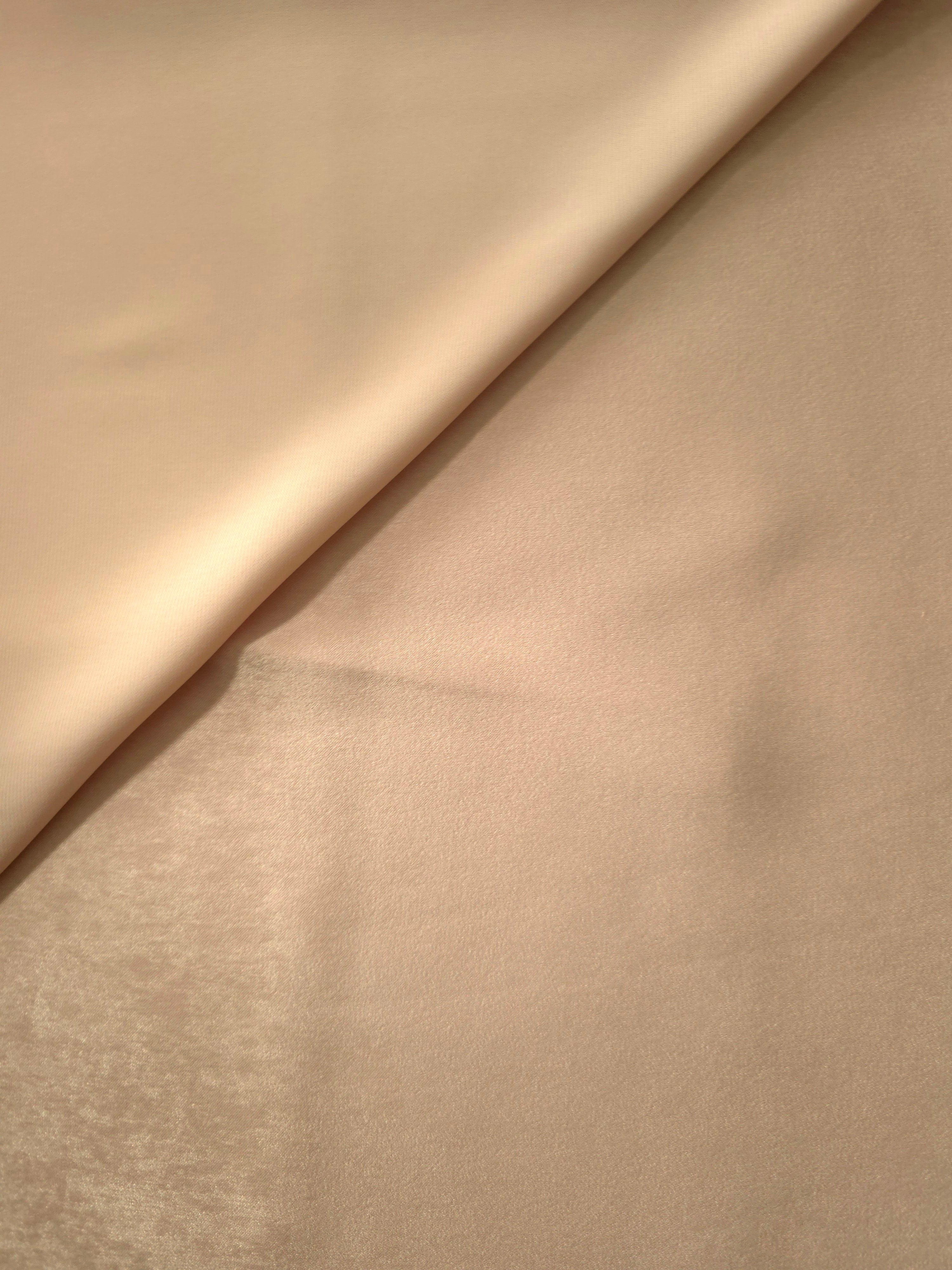 Close-up of Camel Sand Milano sandwashed silky fabric showing its smooth matte texture and soft surface