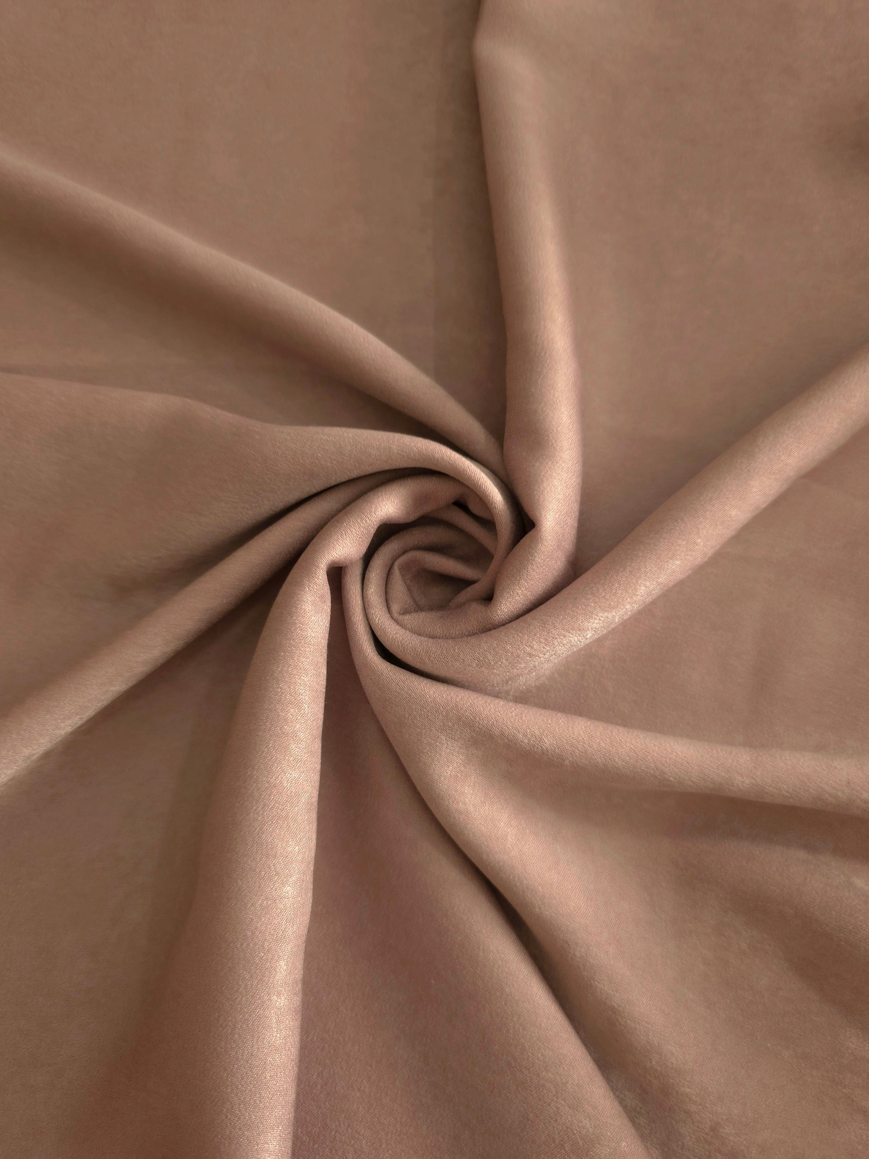 Soft folded detail of Cappuccino Taupe Milano sandwashed silky fabric highlighting its matte finish and supple hand