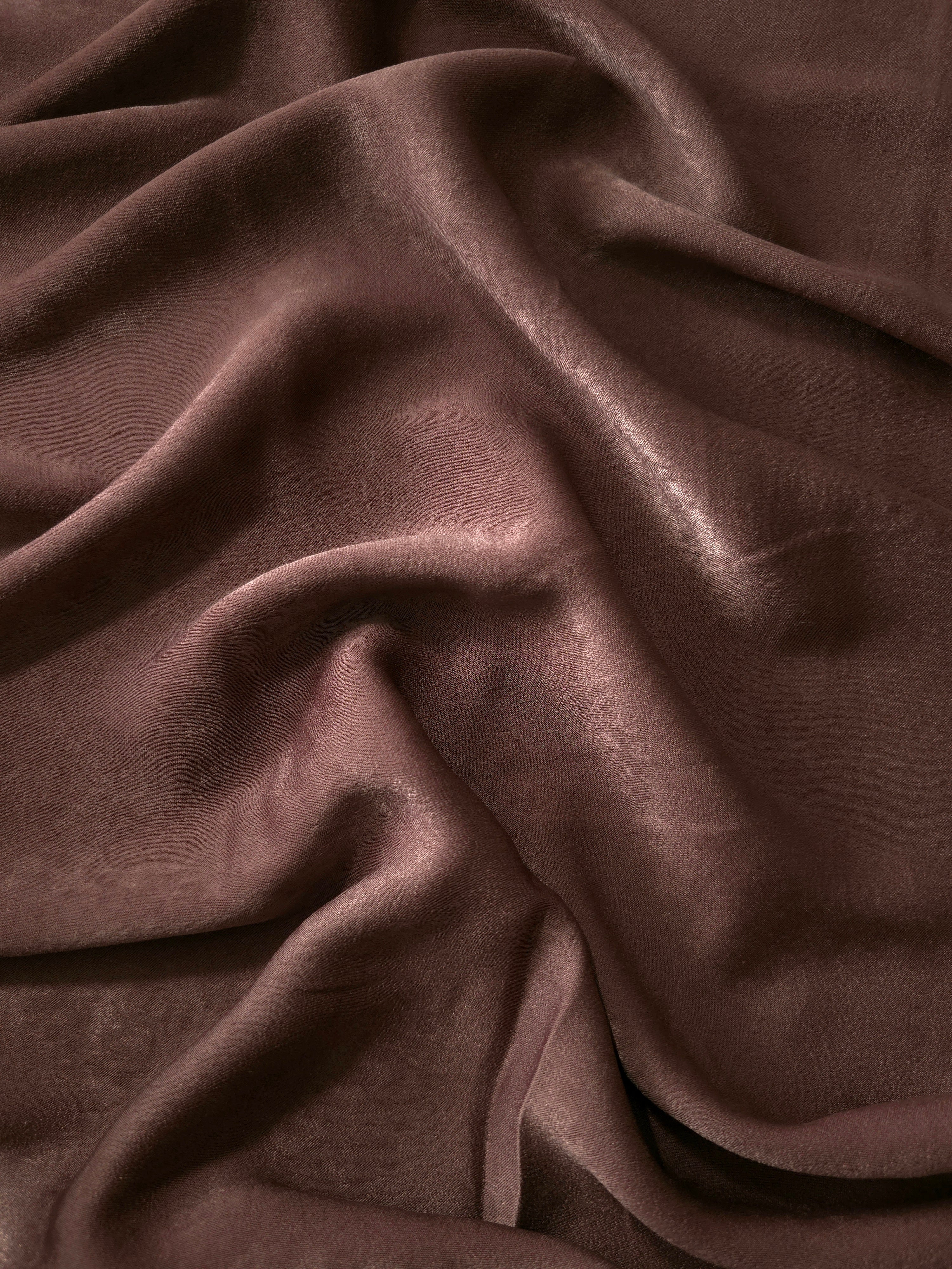Milano matte sandwashed silky fabric in Chestnut Wine, shown as a soft textile for dresses, blouses and apparel