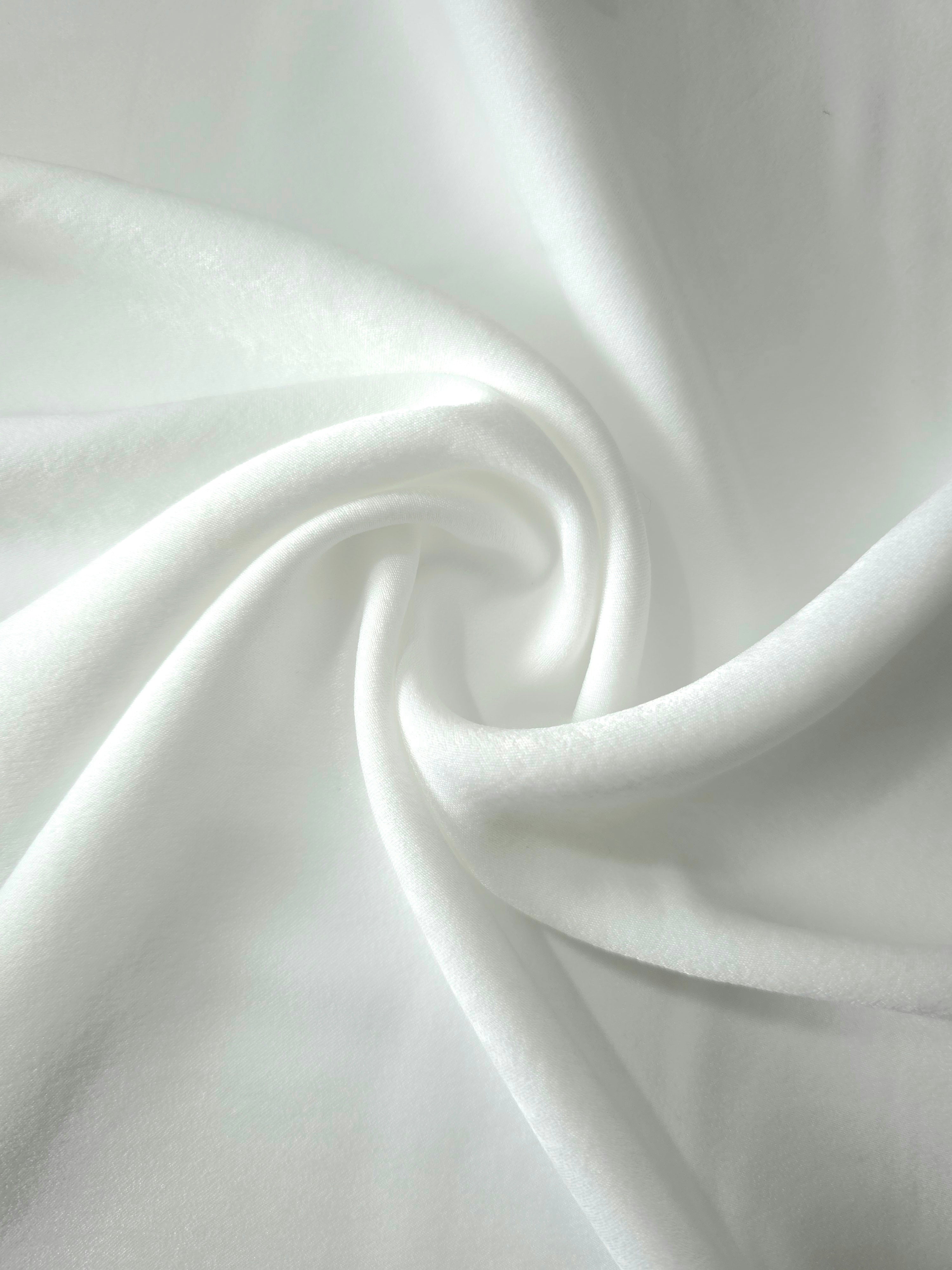 Soft folded detail of Frosted Silver Milano sandwashed silky fabric highlighting its matte finish and supple hand